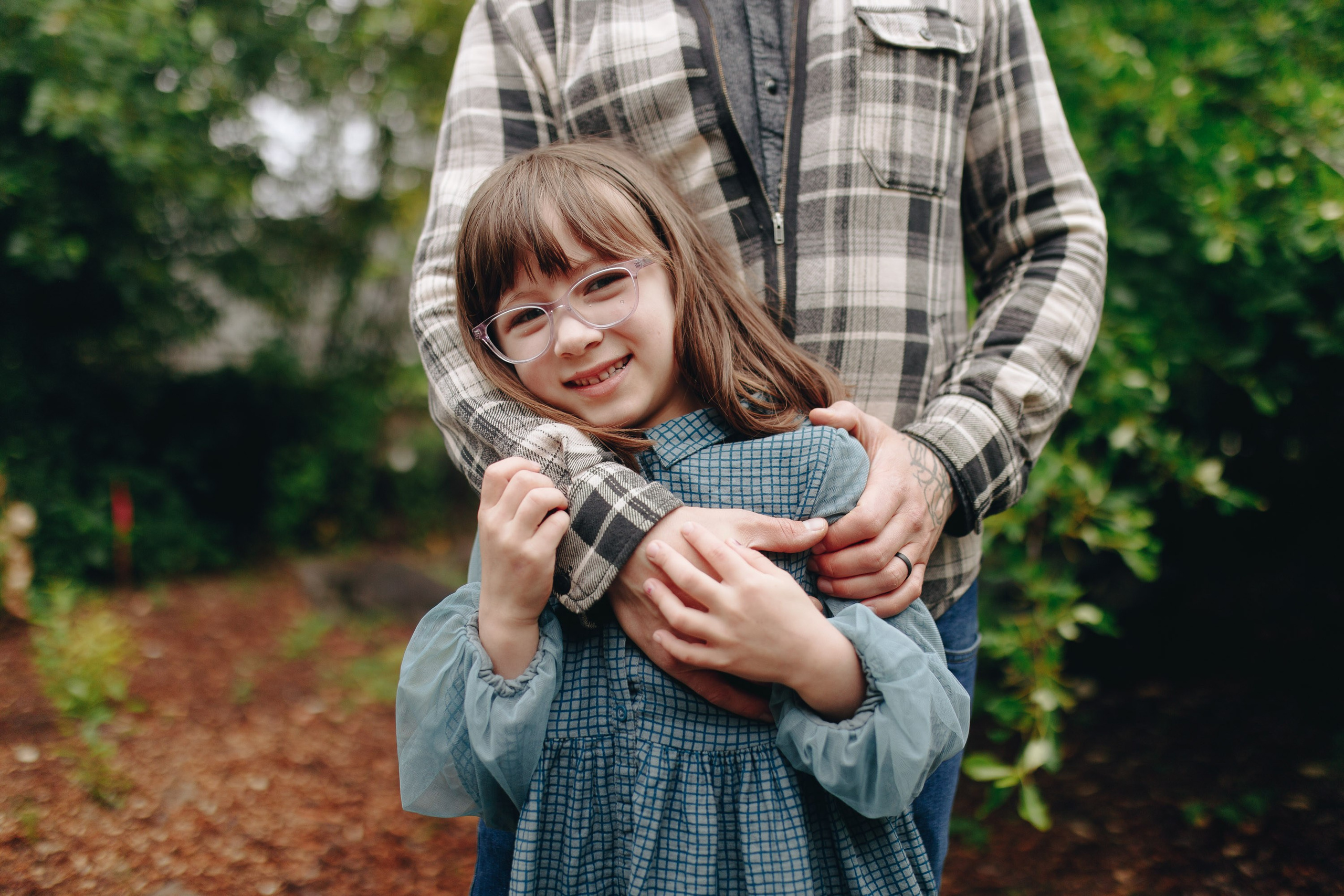 Father holding baby in plaid shirt, cozy family photo