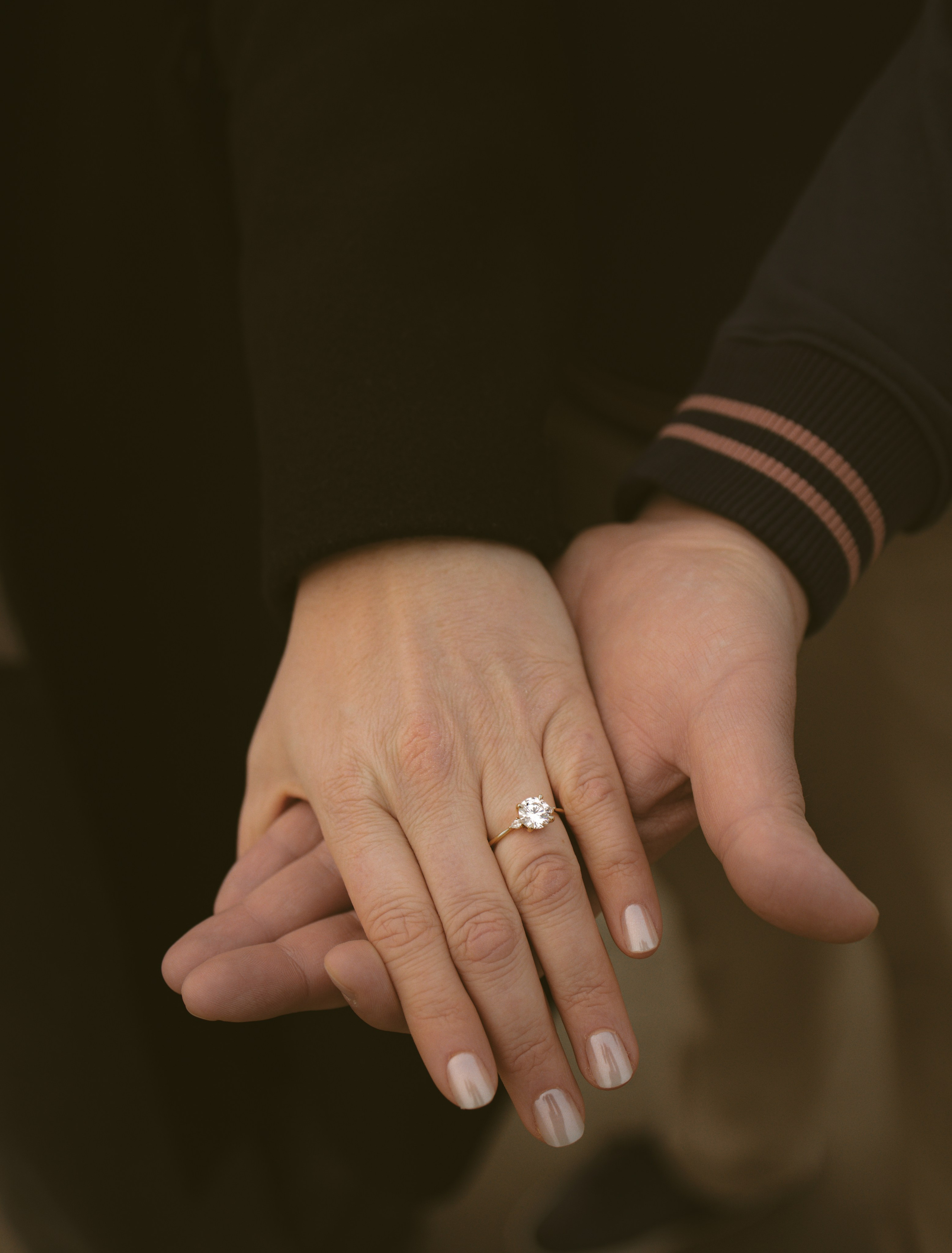 Couple’s hands with engagement ring during New Jersey Ocean city proposal  photography session