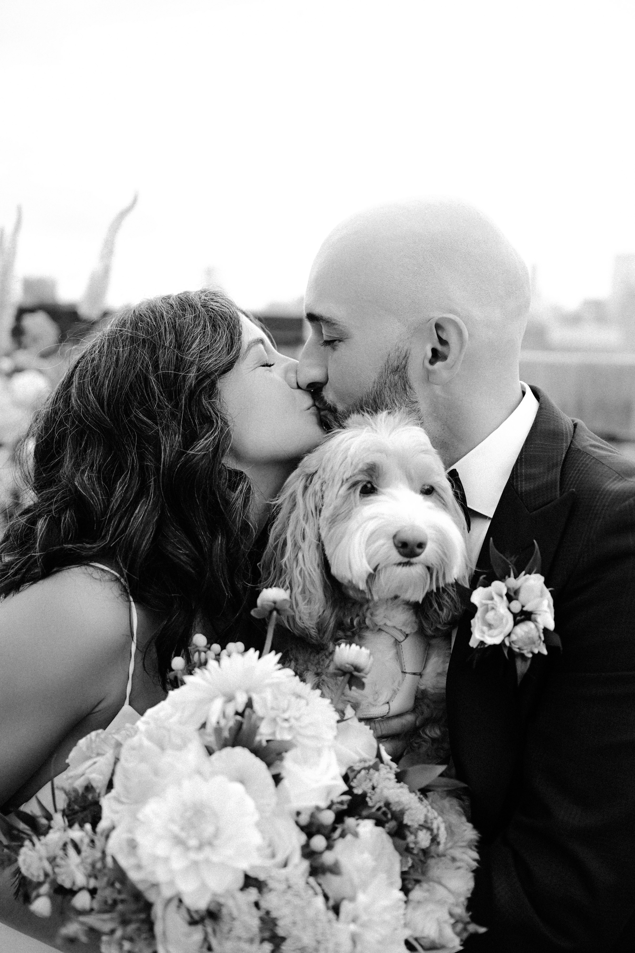 a man and woman kissing with a dog