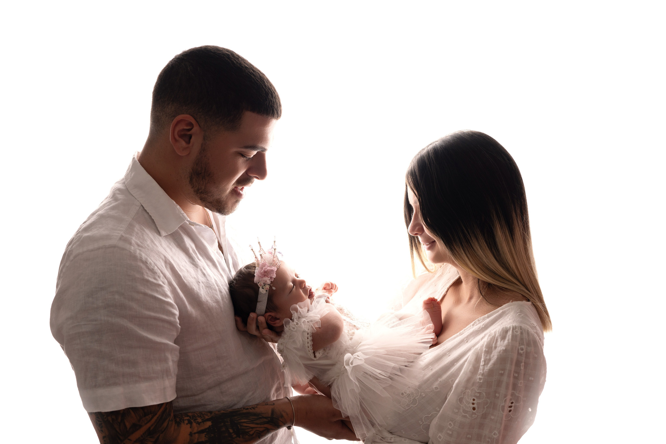 Family portraits in contrast light with a newborn baby girl in Tampa, Florida.