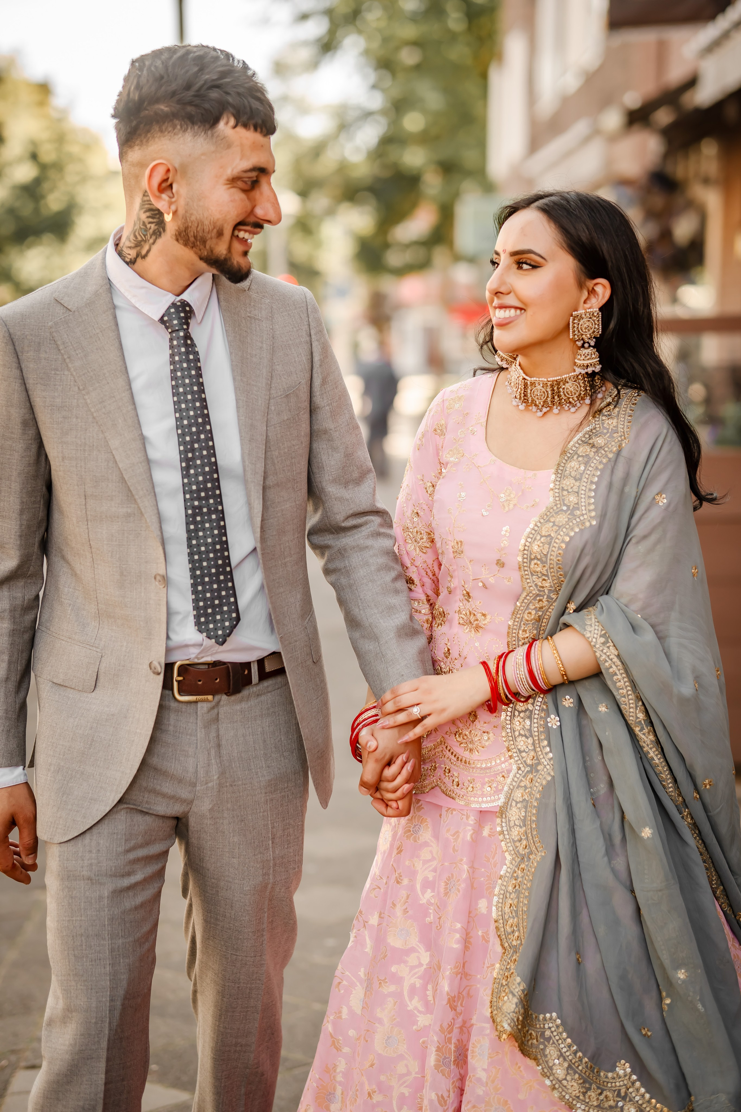 man and woman holding hands and walking in amsterdam