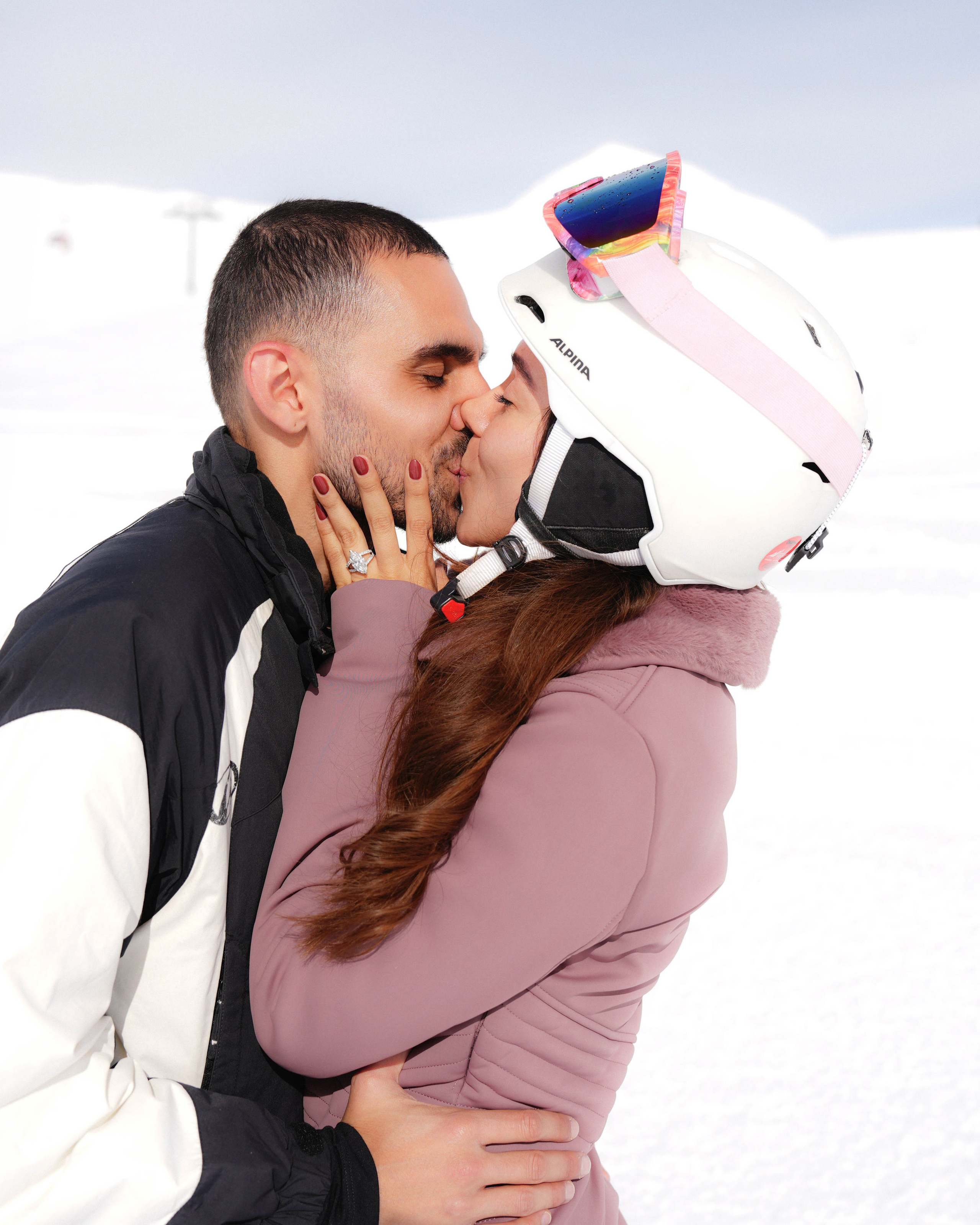 Couple kissing after proposal in mountains