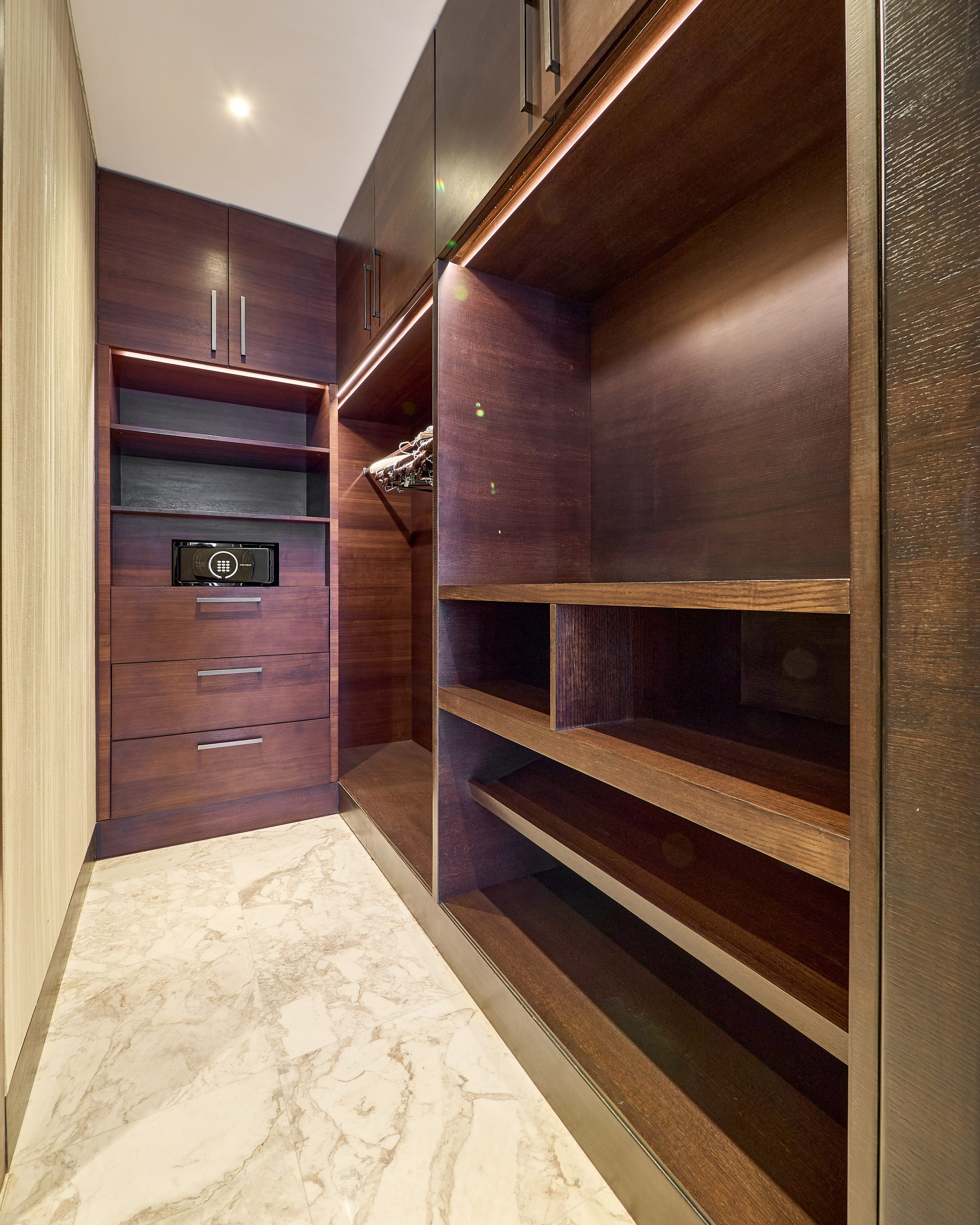 Spacious walk-in wardrobe in luxury apartment, photographed for premium real estate and hospitality marketing.