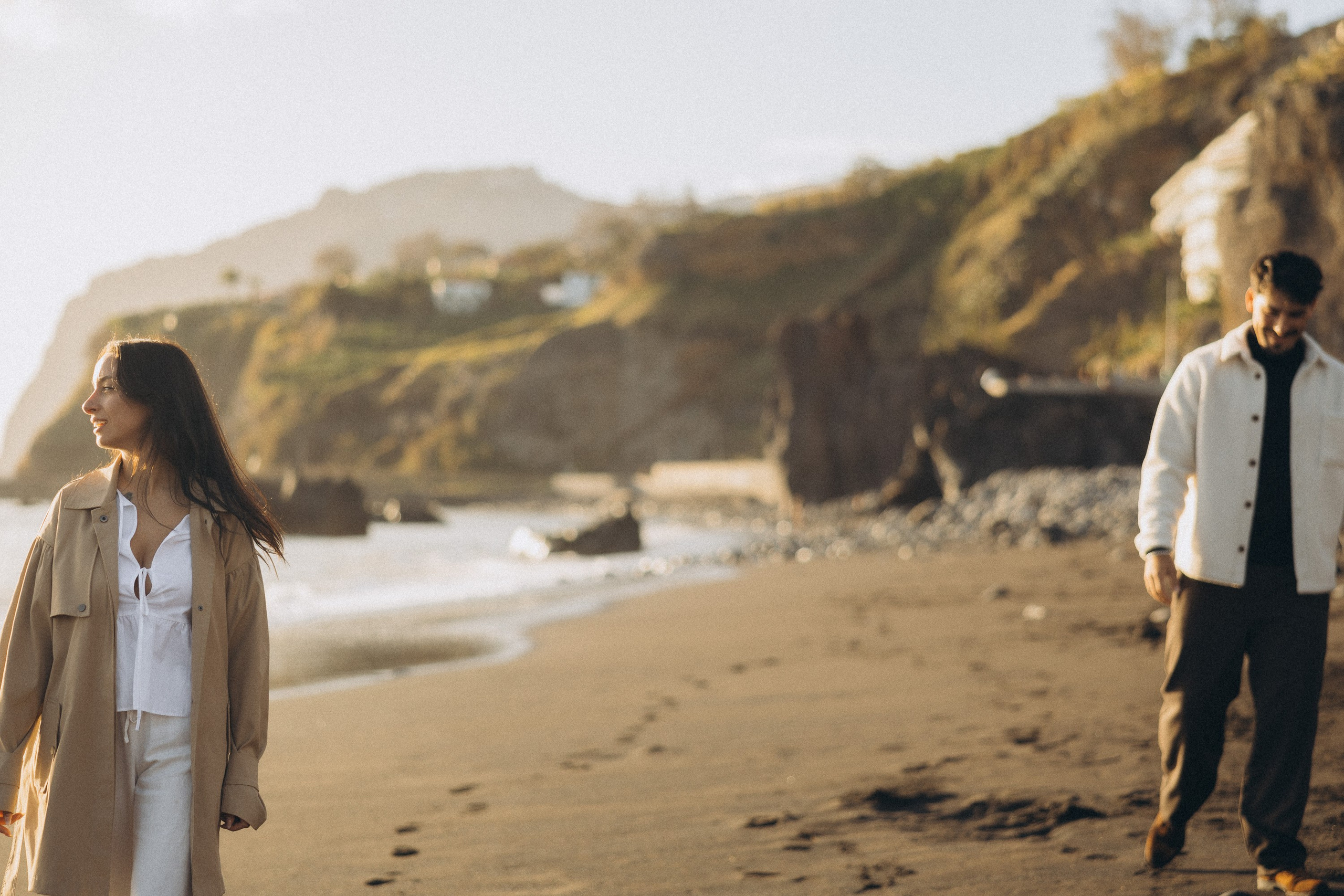 Couple sharing a romantic moment during sunset on Madeira Island, with the ocean and cliffs in the background