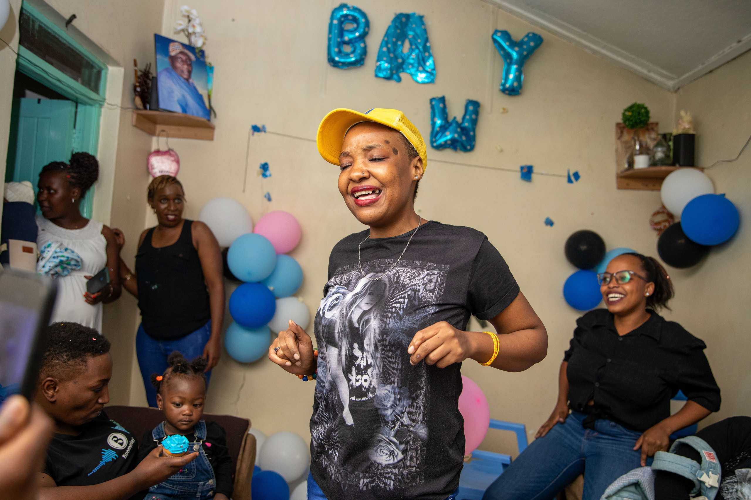 Woman dancing joyfully at a baby shower in Nairobi, Kenya