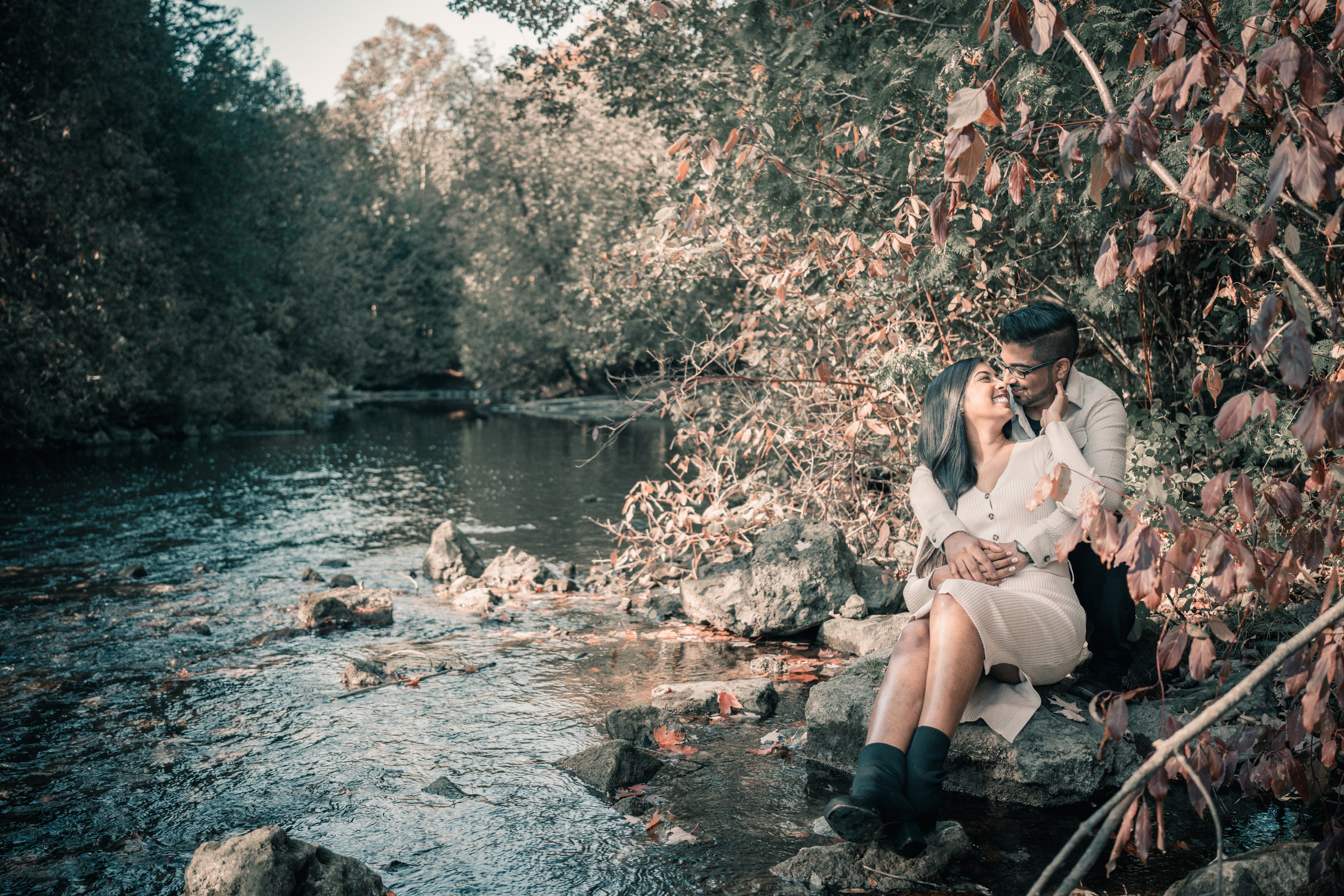 Couple walking through a golden autumn park, capturing their engagement moments