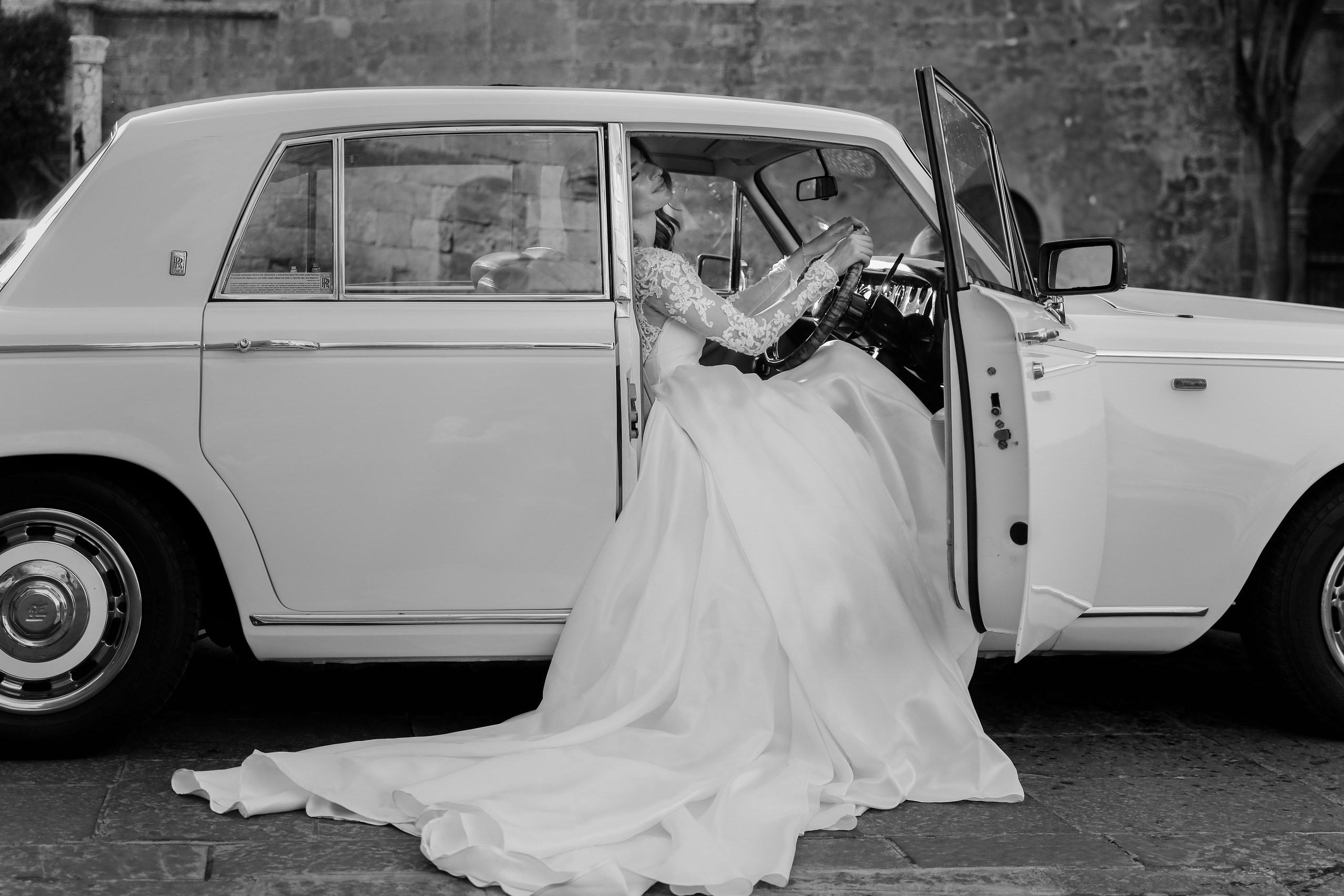 A portrait of a beautiful bride  in Rolls Royce in old town of Rhodes island, Greece