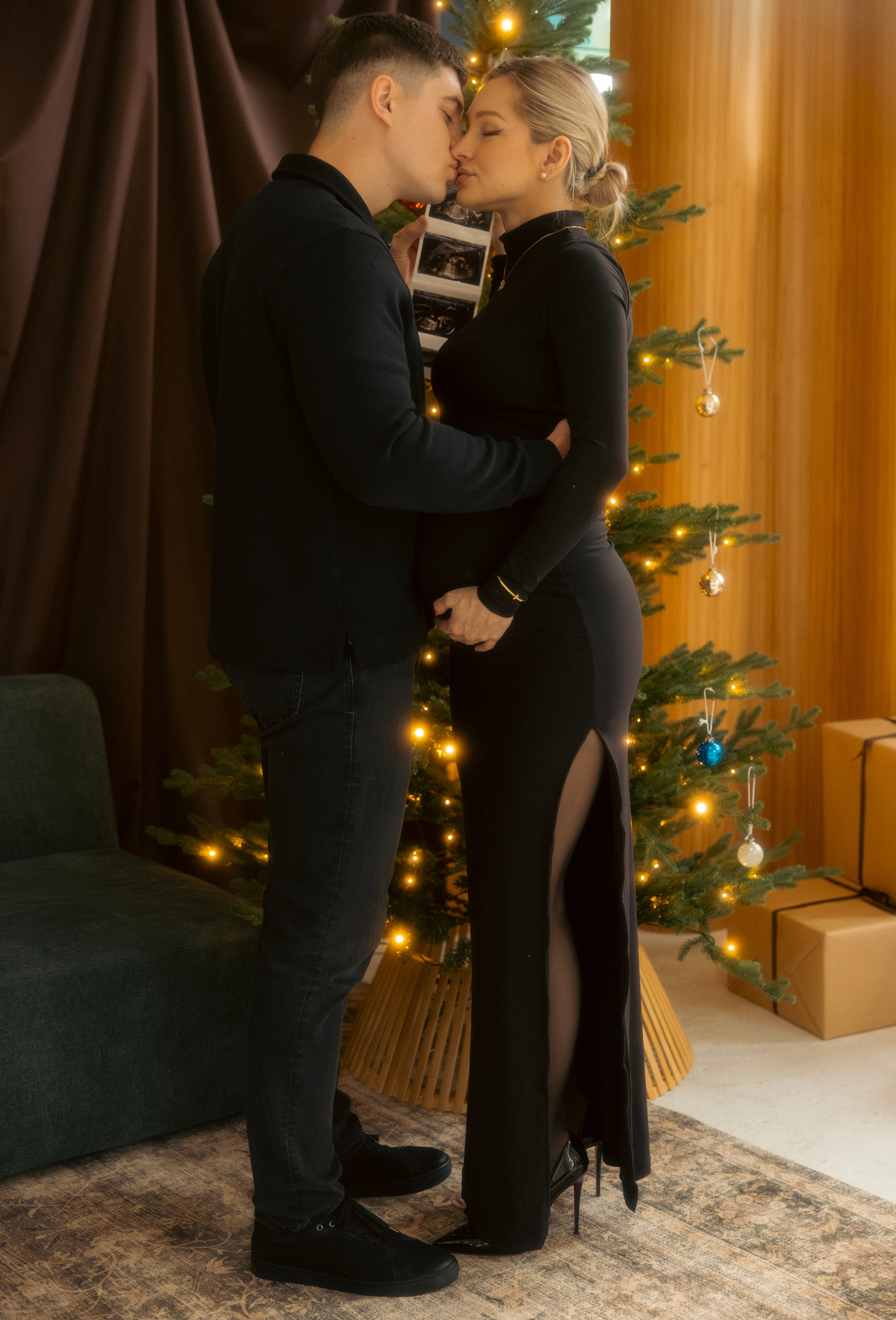 Expecting couple embracing during a cozy holiday maternity session