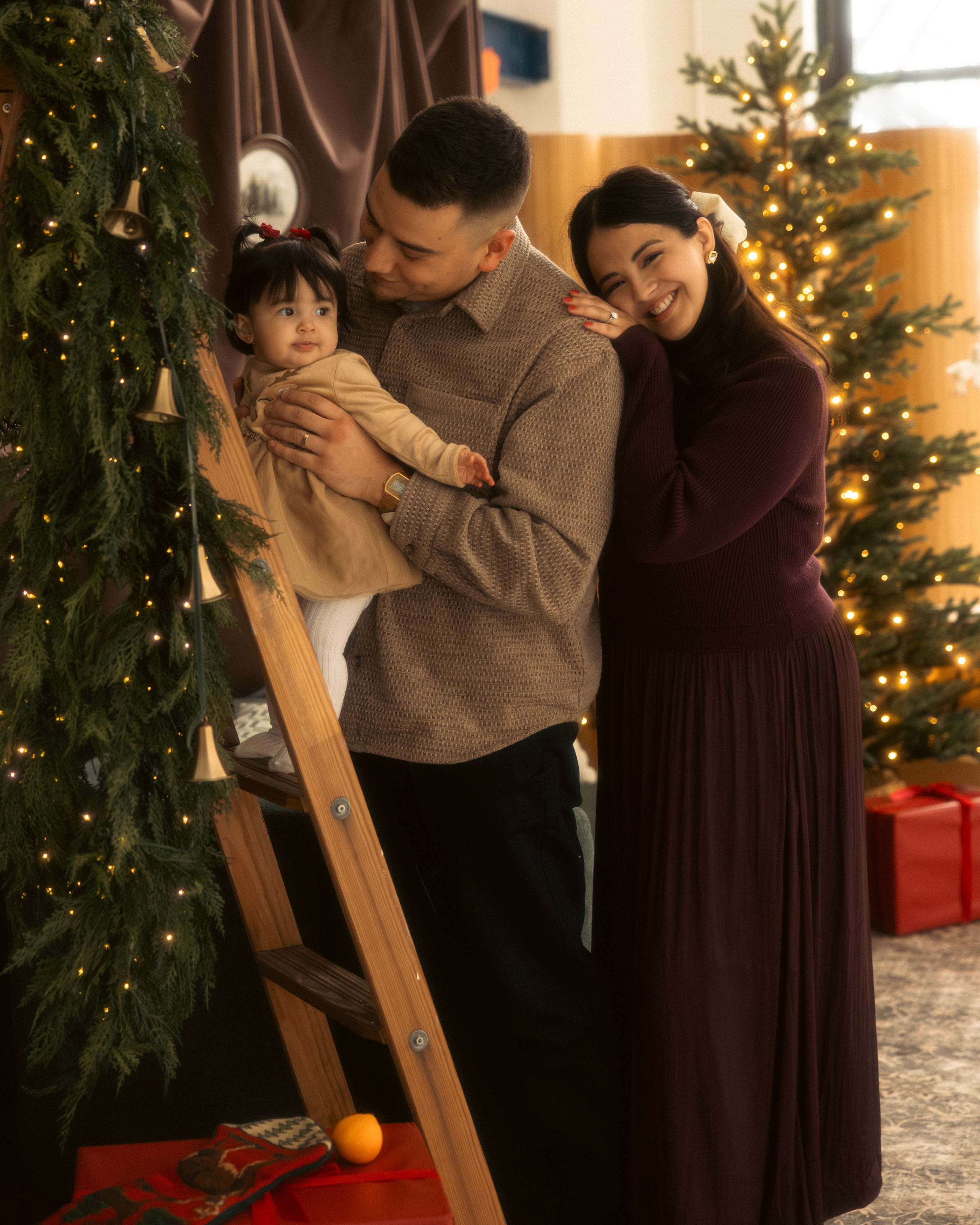 Family sharing a playful moment during a cozy Christmas photo session