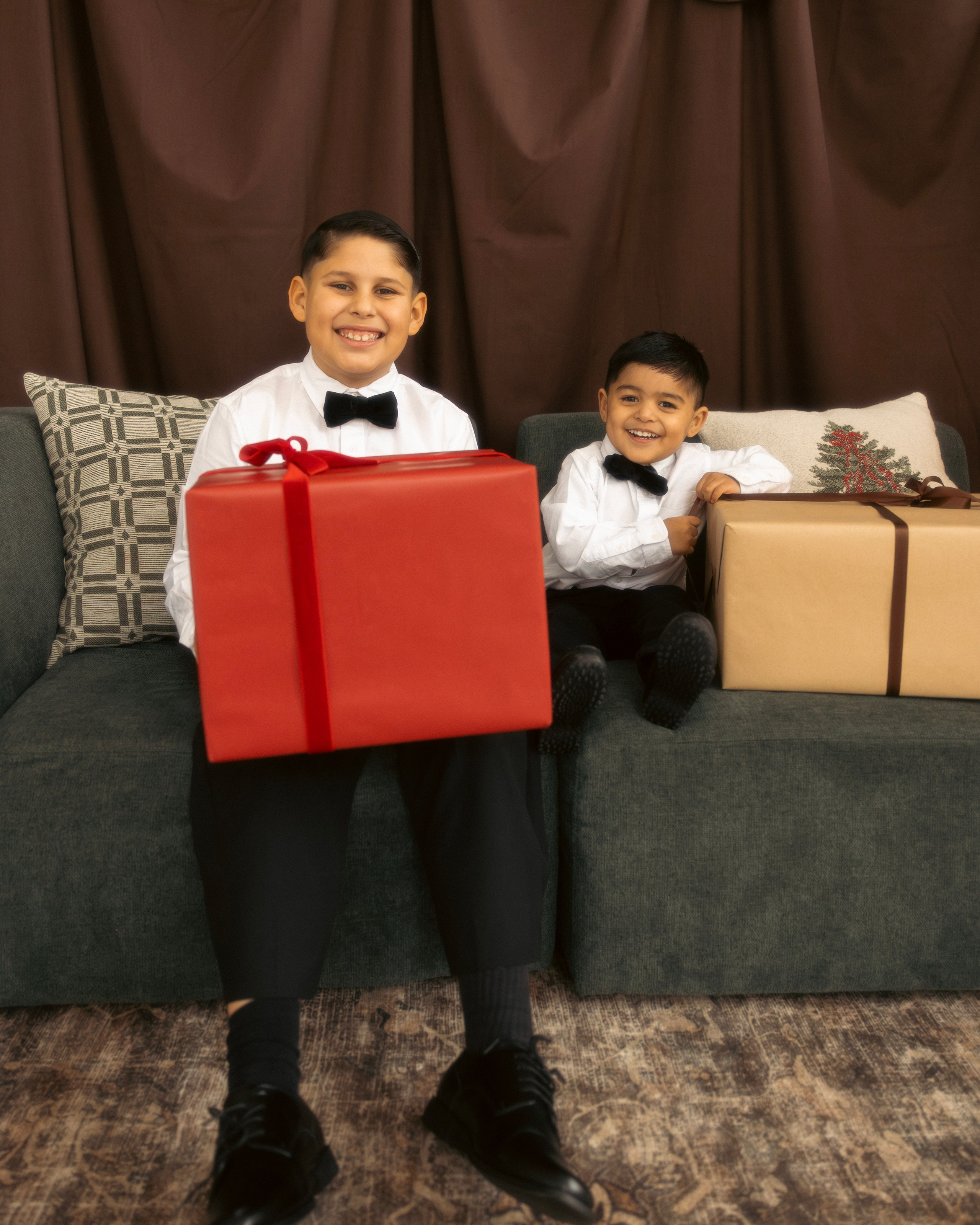 Children holding Christmas presents during a festive holiday photo session