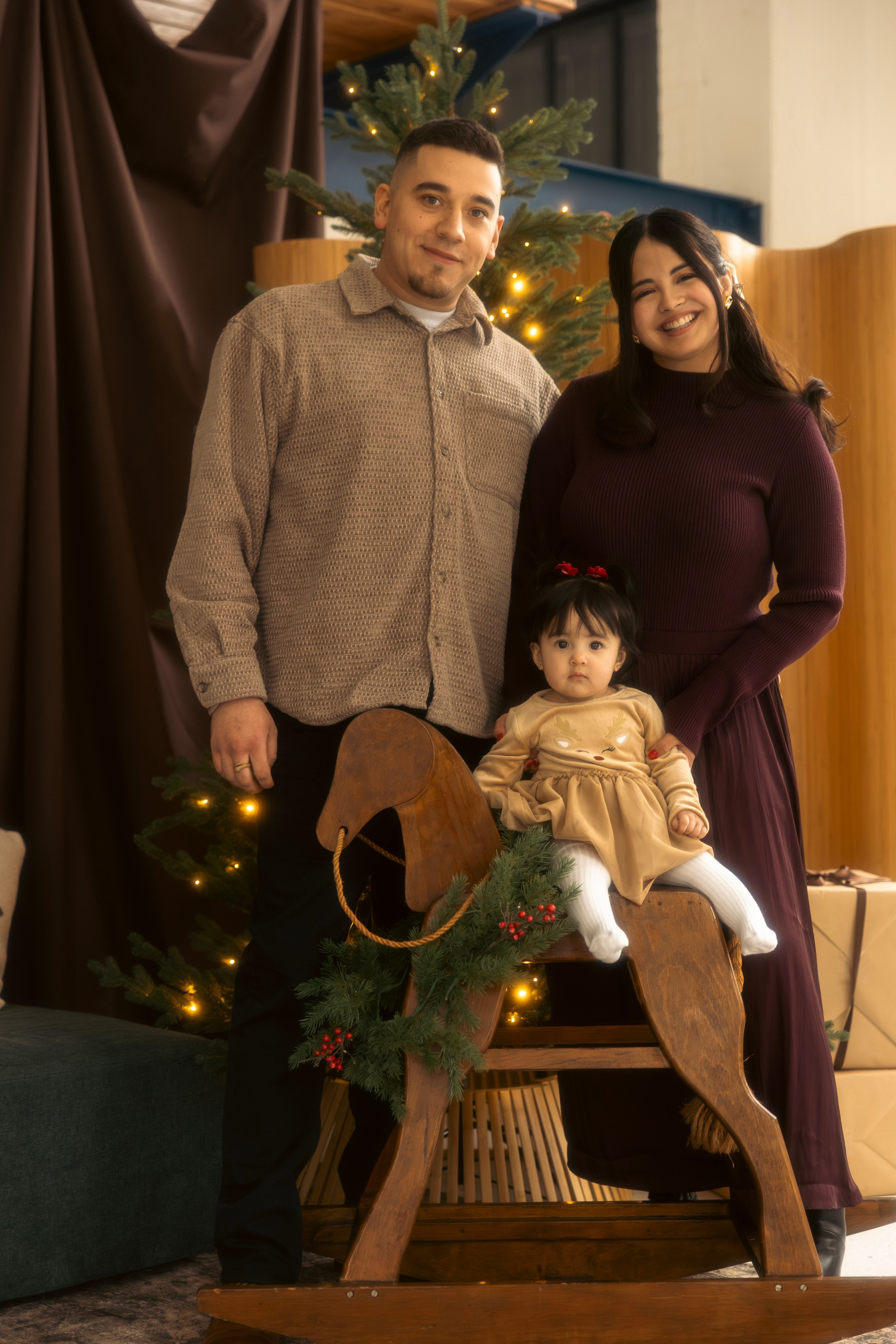 Parents playing with their child during a warm holiday family photo session