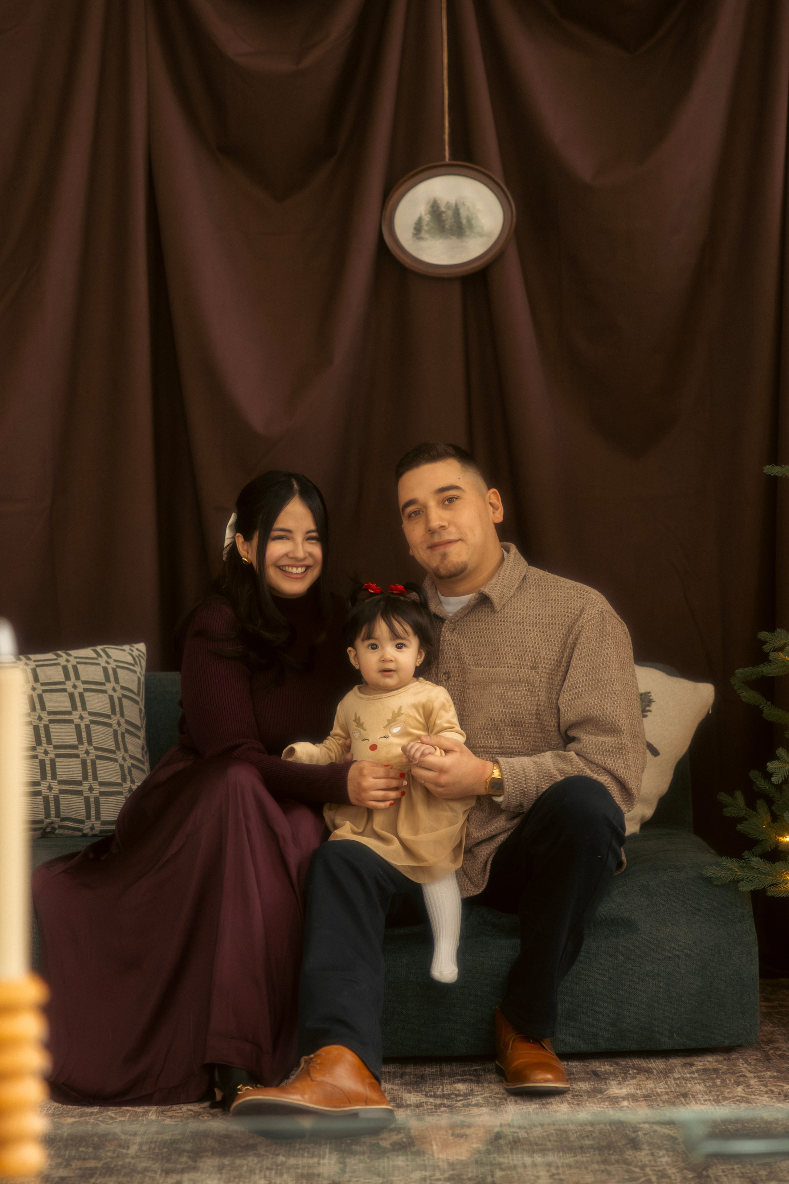Family sitting together by the Christmas tree during a cozy Chicago Christmas session