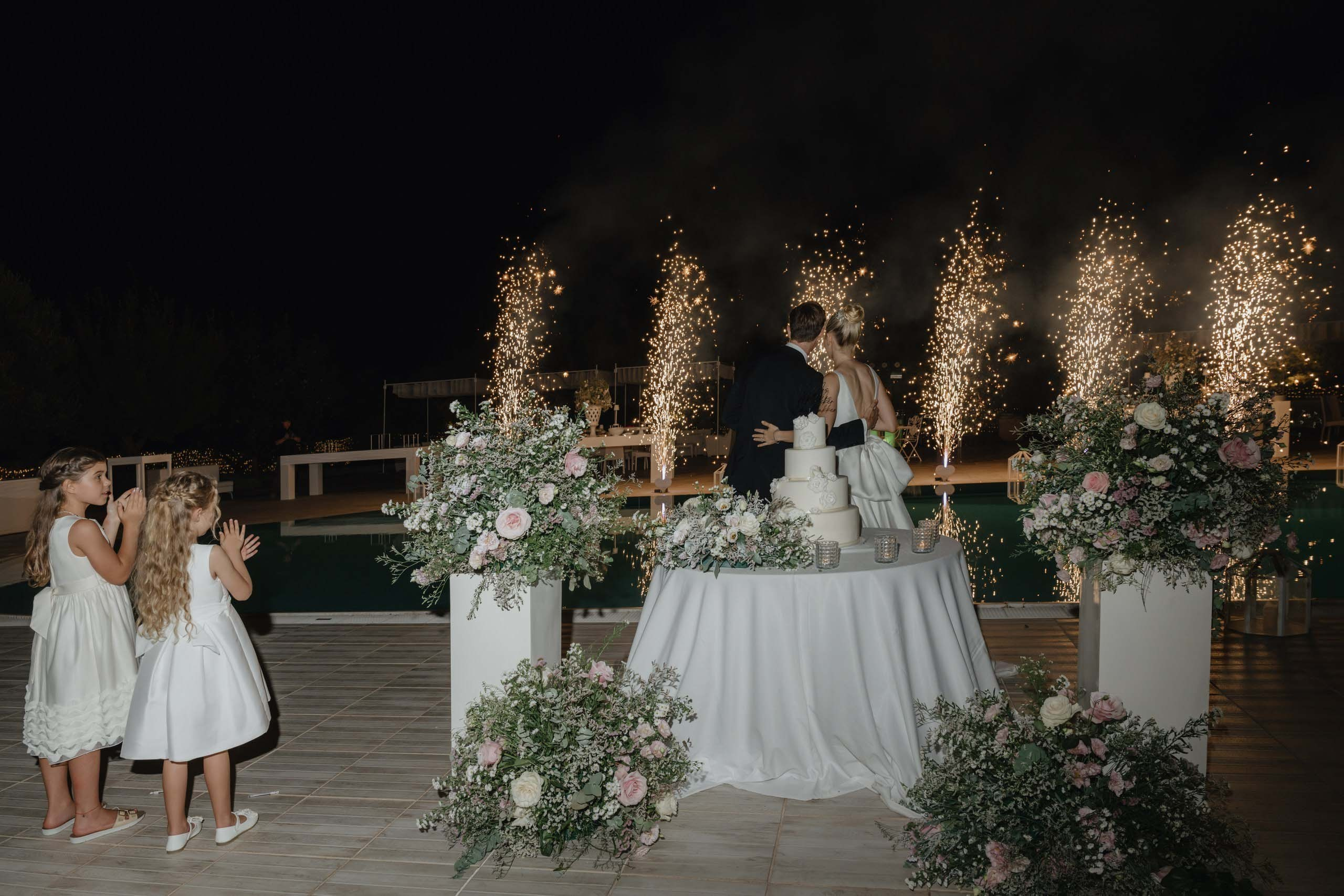Wedding cake moment with sparks and lights, luxury destination wedding in Puglia Italy