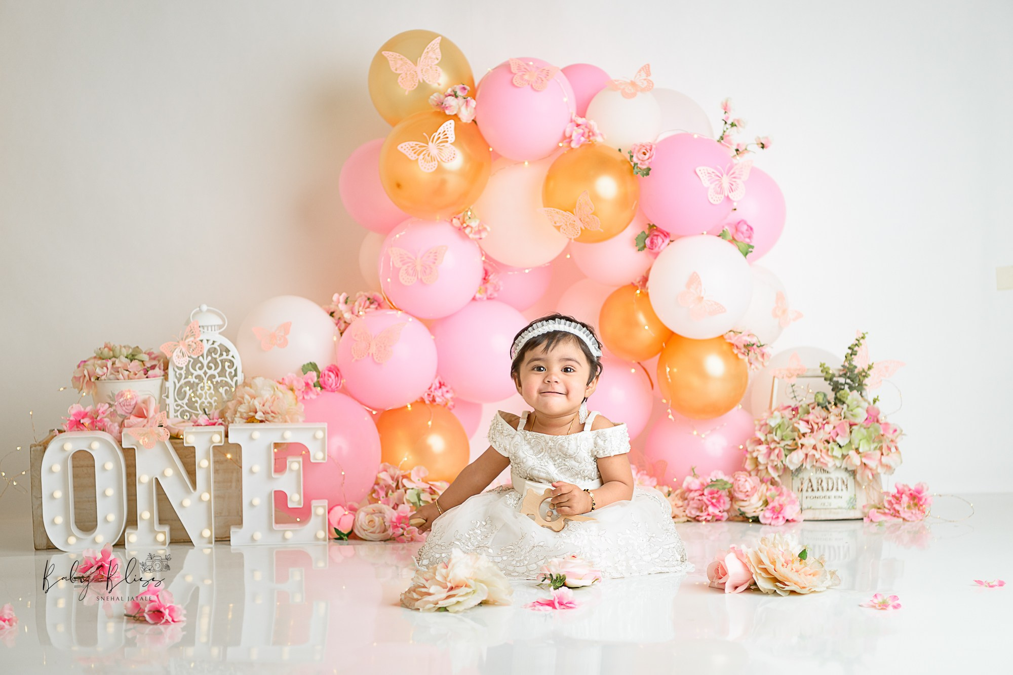 golden, pink balloons with butterfly in background