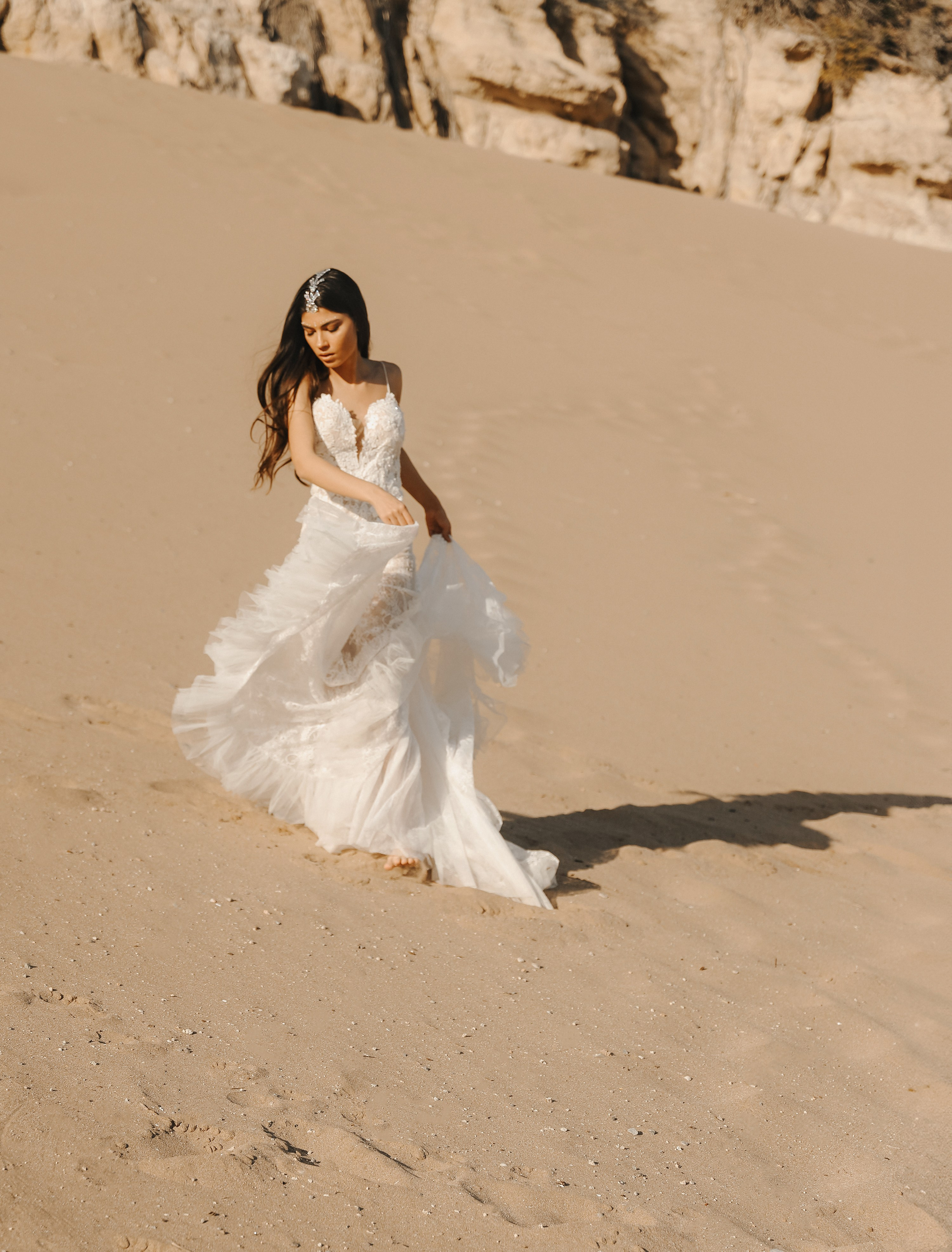 Art photoshoot of a girl in a wedding dress in the desert on a beach Tsampika in Greece