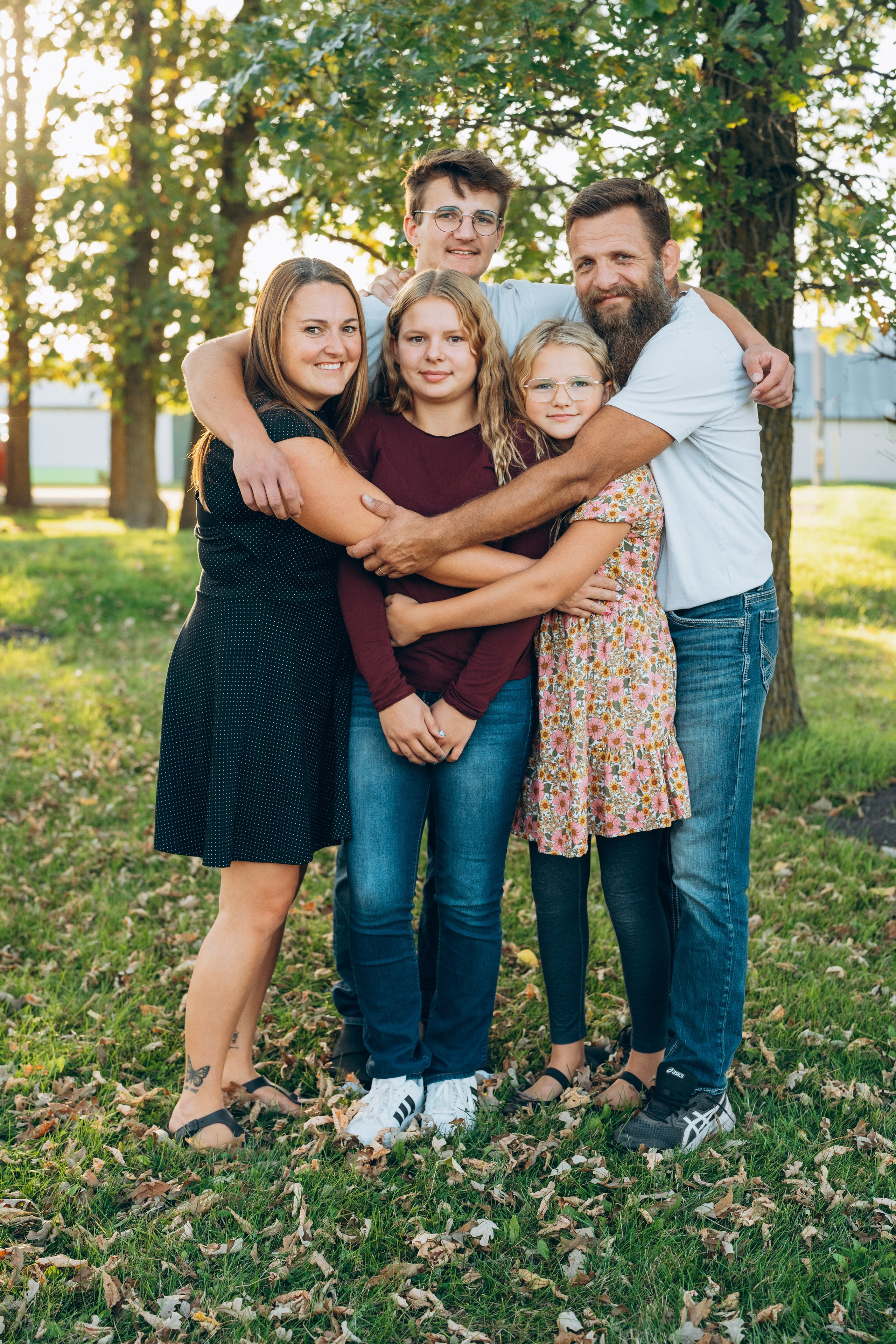 Parents cuddling with kids in a park