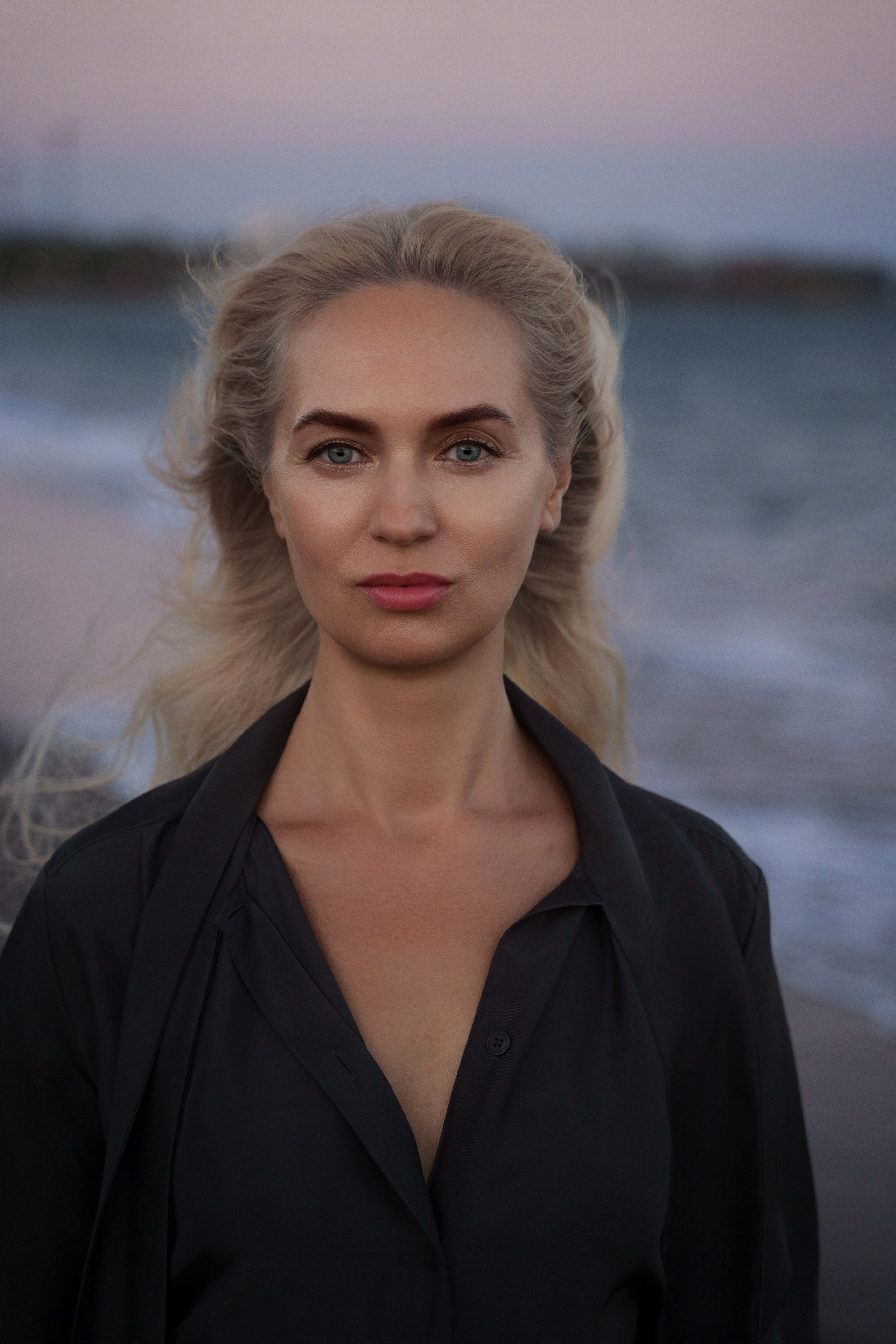 Stylish beach portrait of a young blonde woman on the shores of Estepona