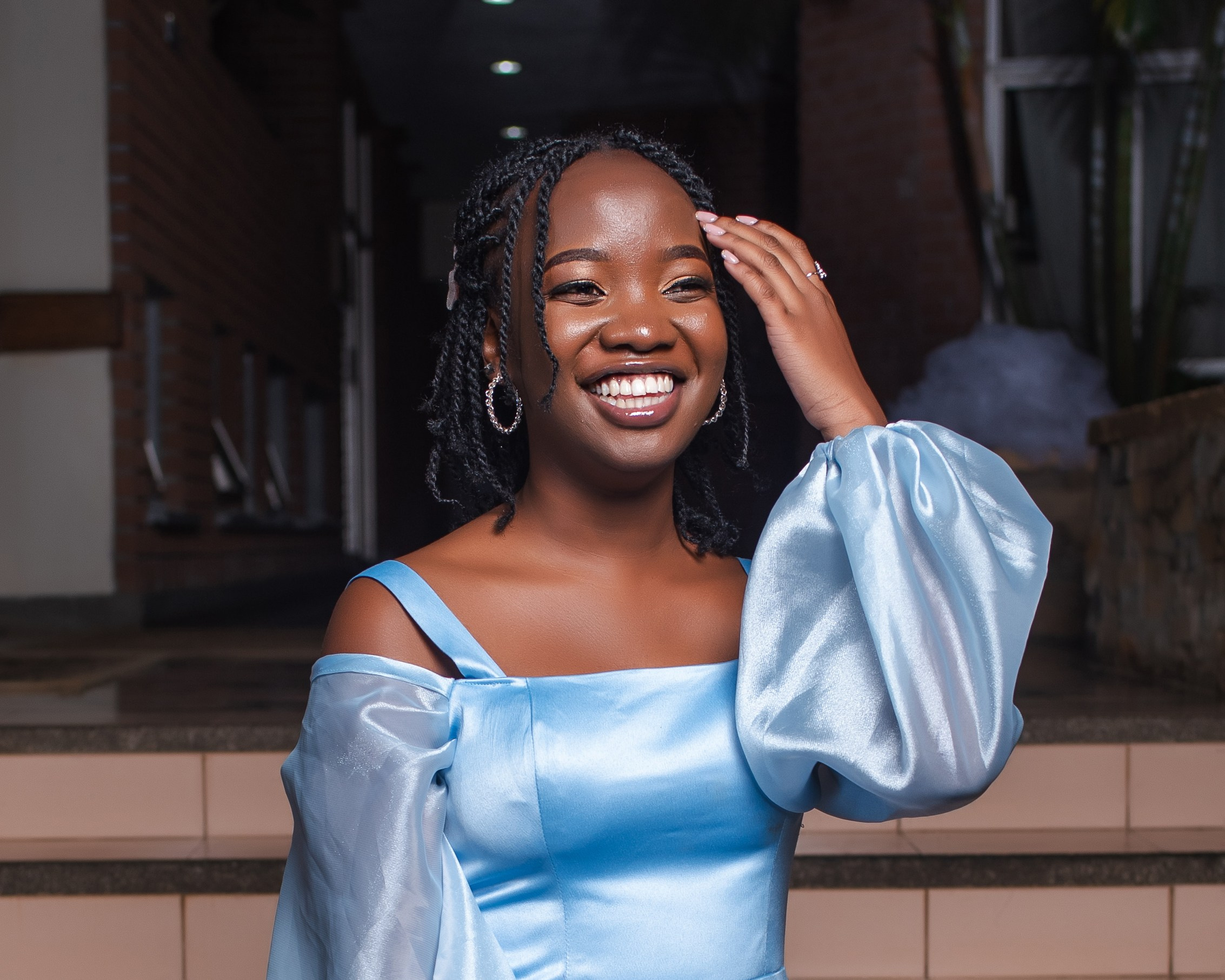 Smiling young woman in blue off-shoulder dress — candid portrait by Nick Ouma Photography, Nairobi