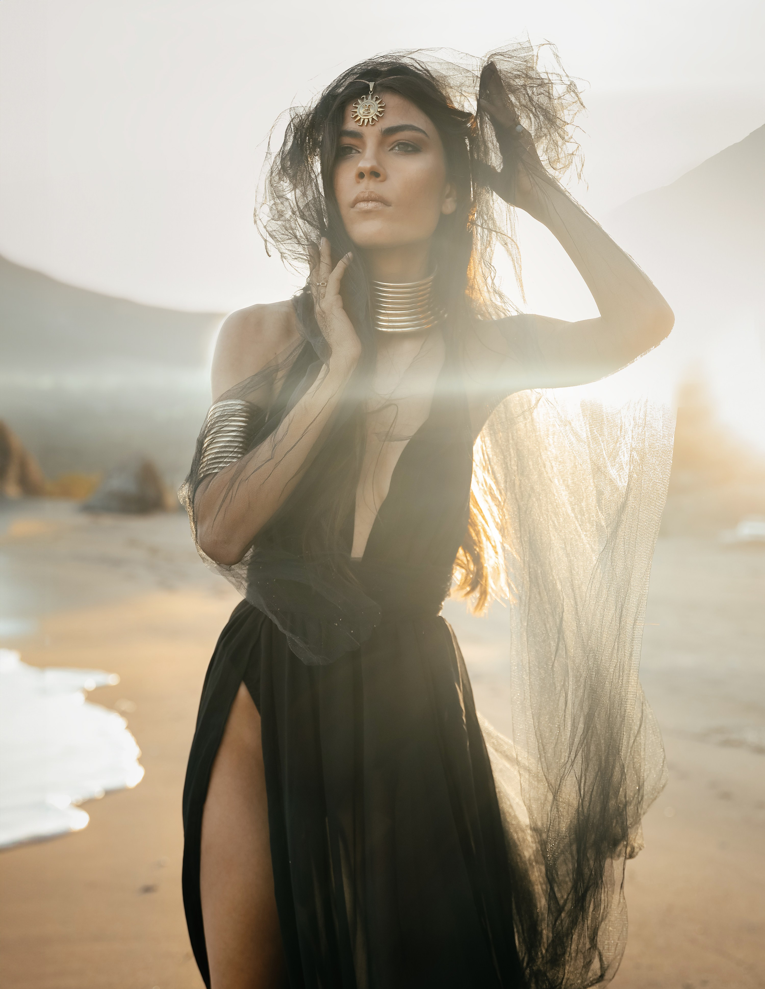 A chic girl in a black dress in the Desert against the setting sun. Rhodes island, Greece
