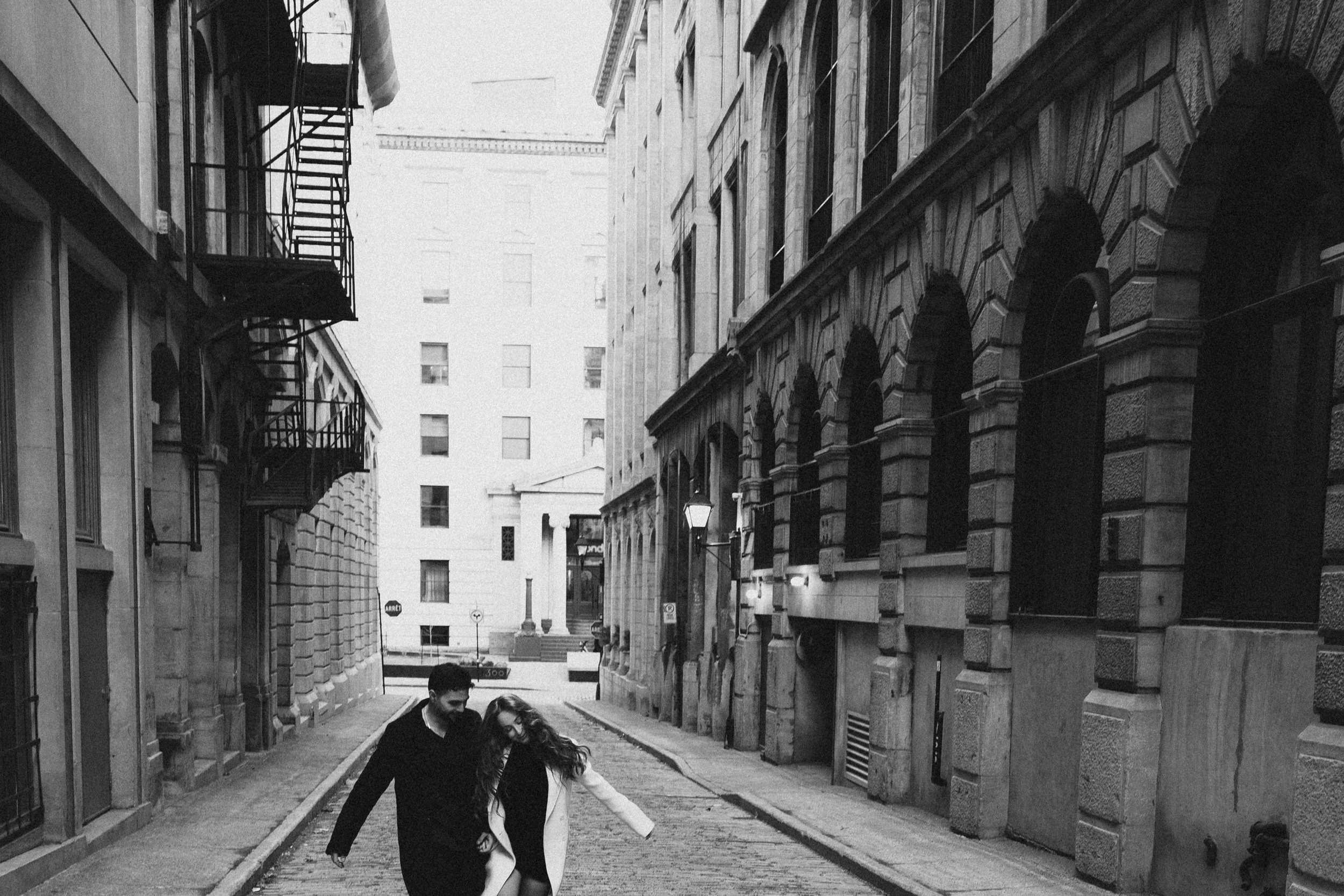 Couple walking together in narrow street of Old Montreal