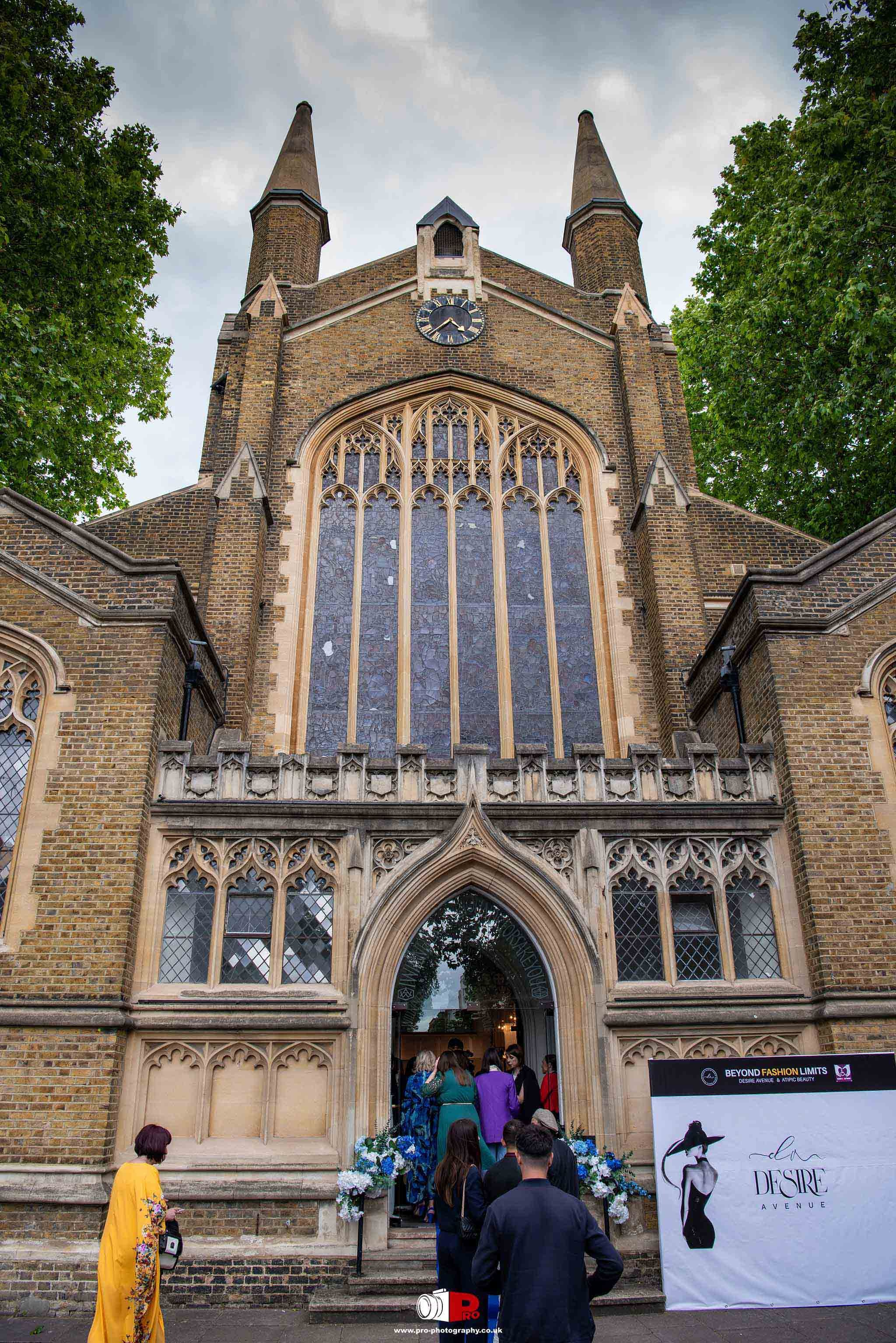 Exterior view of a grand Gothic church with guests entering for the Beyond Fashion Limits event.
