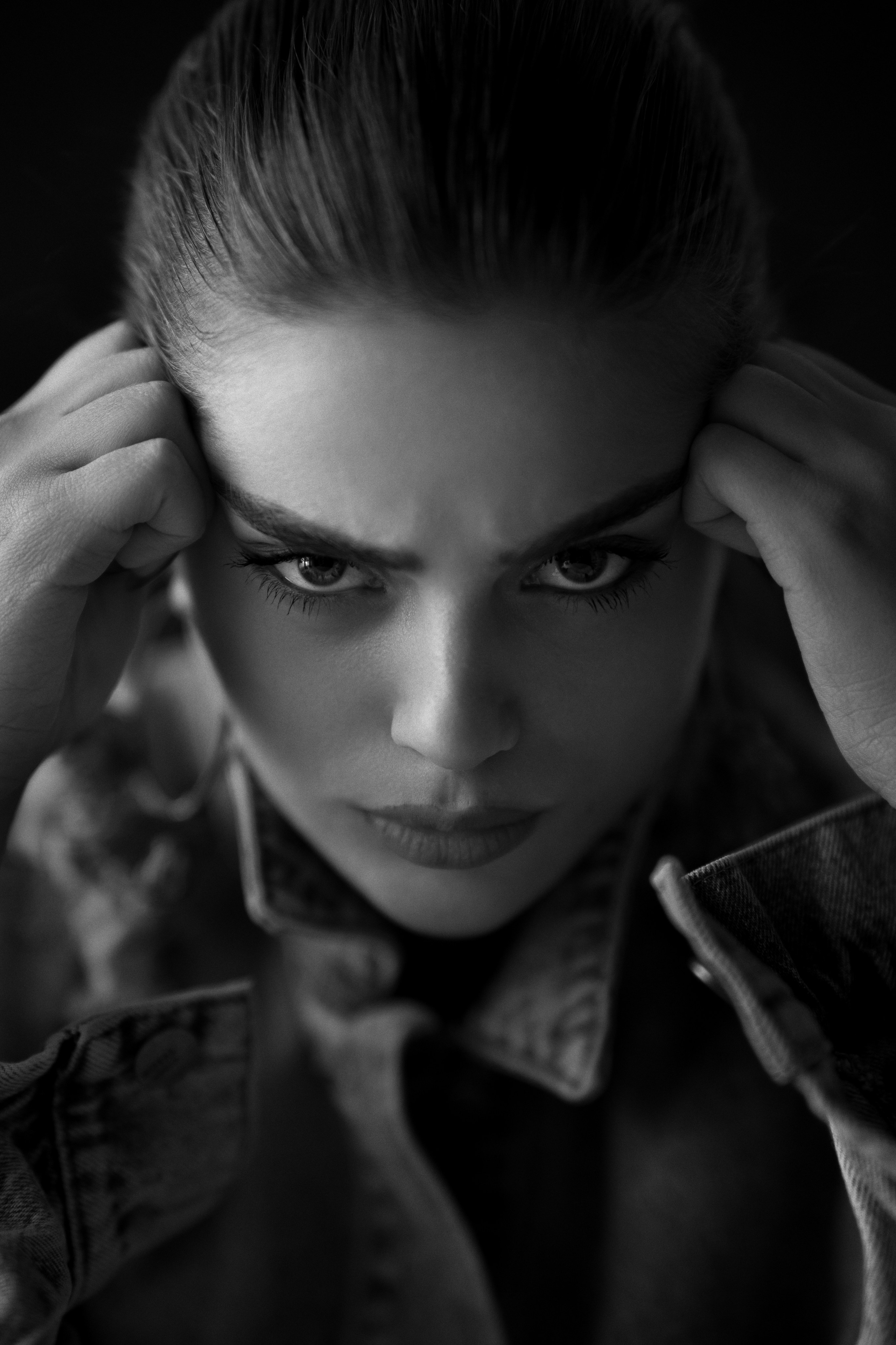 Black and white dramatic portrait photography by Mehran Hadad with an intense facial expression and cinematic studio lighting.