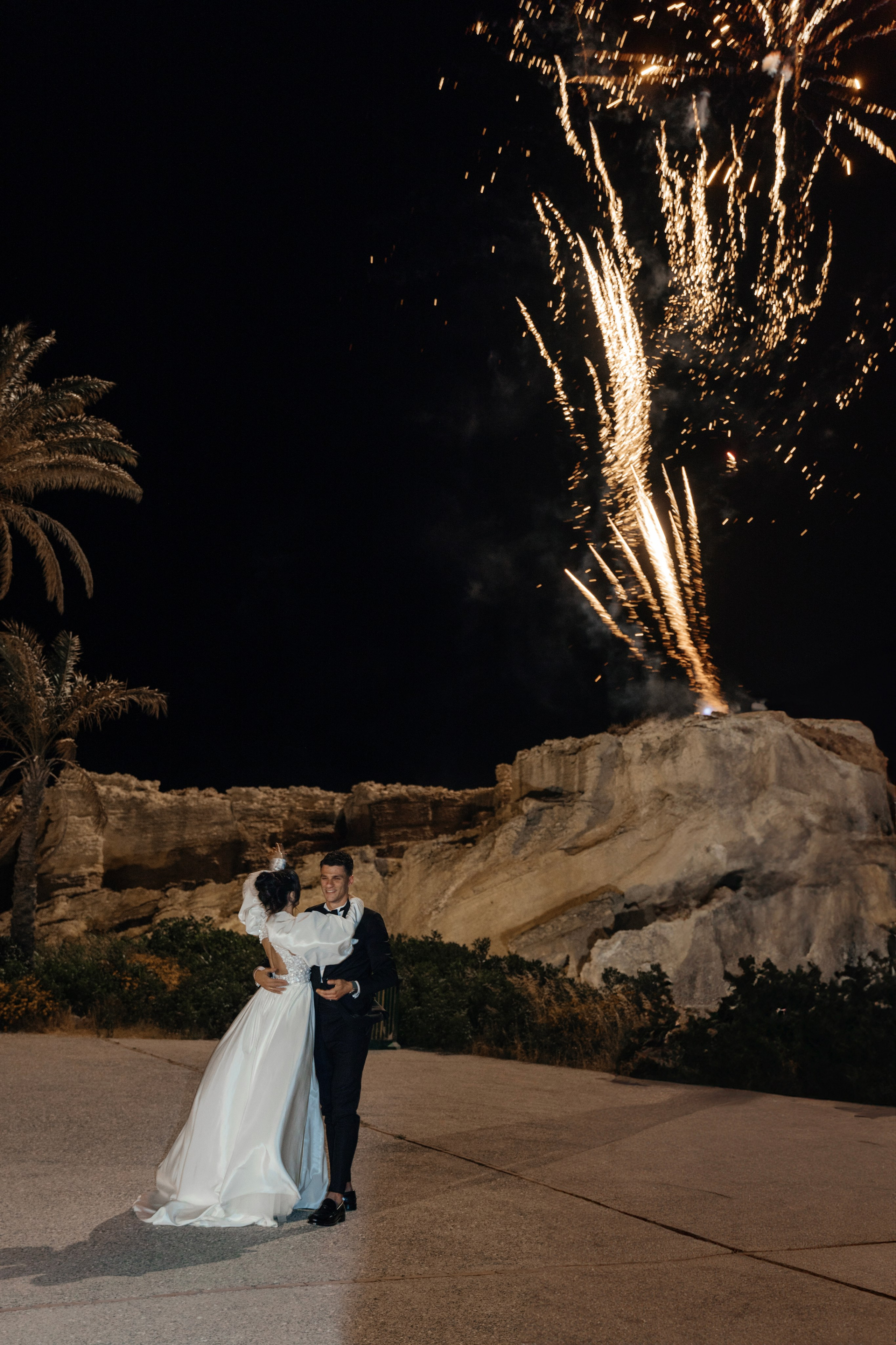 Bride and groom are watching the firework. Rhodes Greece