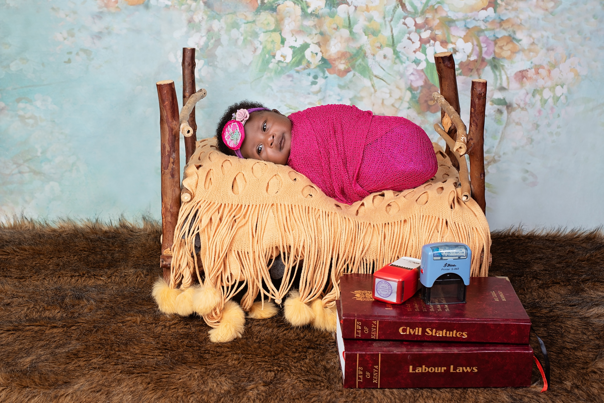 Black baby girl in wooden bed  3 weeks newborn photo shoot Mombasa Kenya