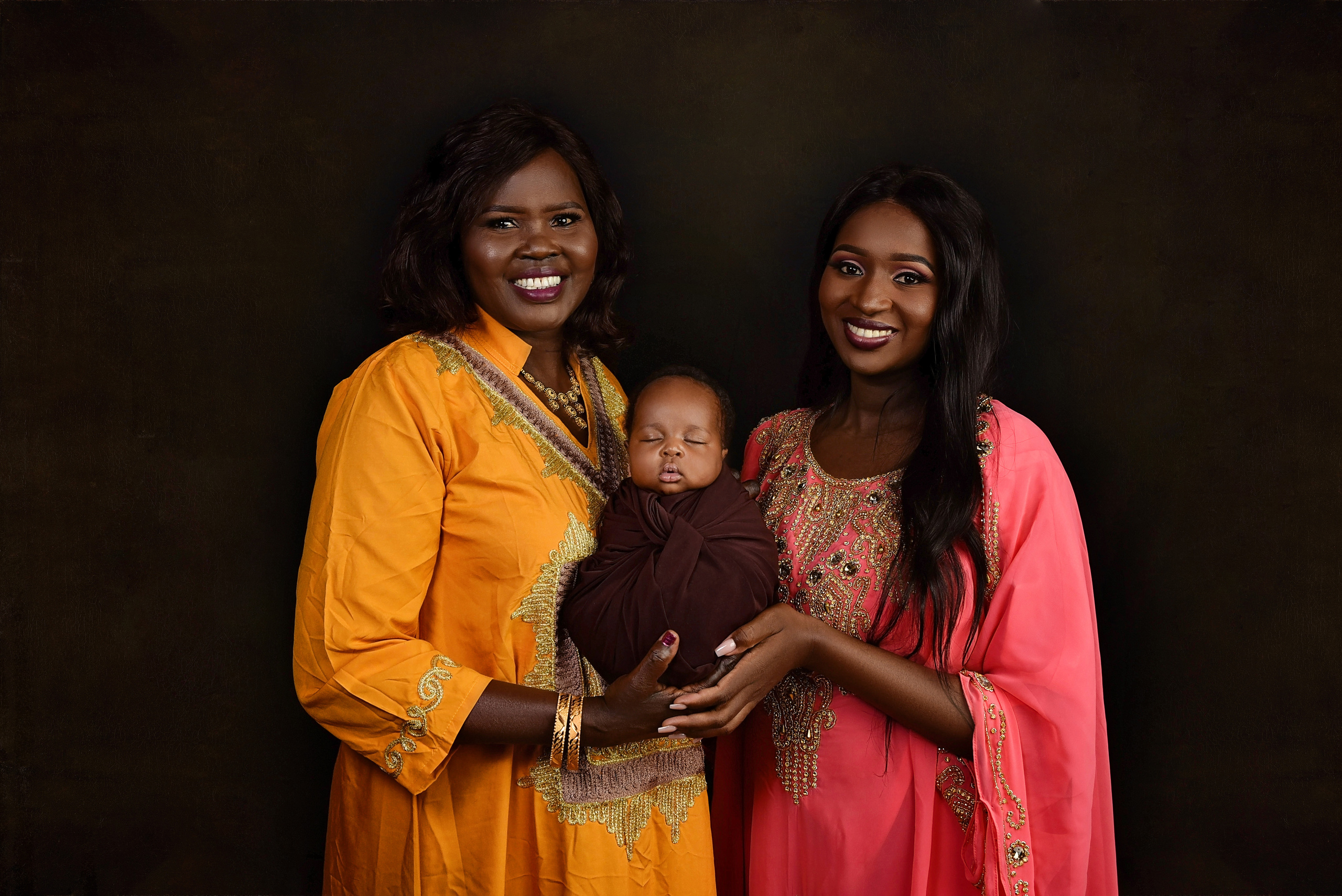 African mama and grand mother with newborn baby boy from South Sudan Nairobi Kenya