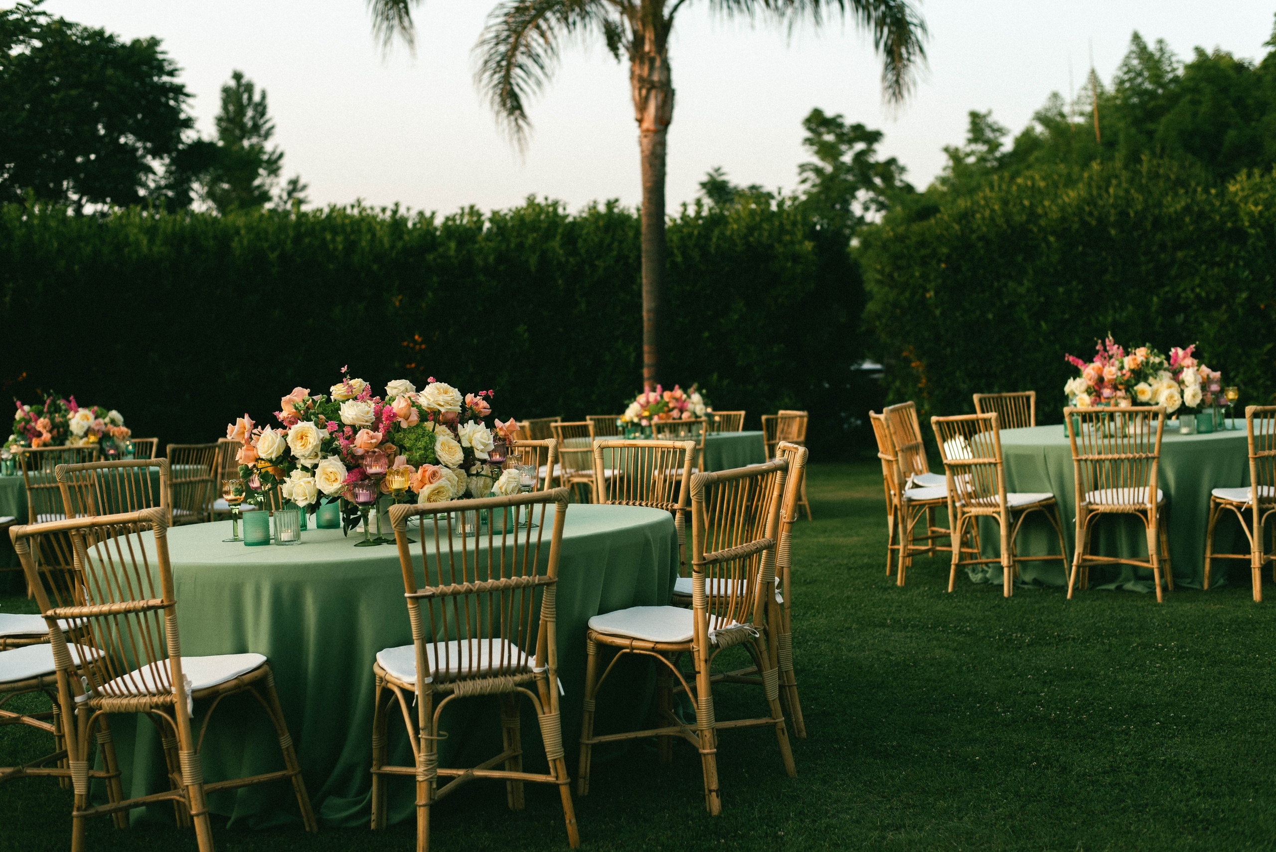 Elegant outdoor garden wedding table setup with floral arrangements
