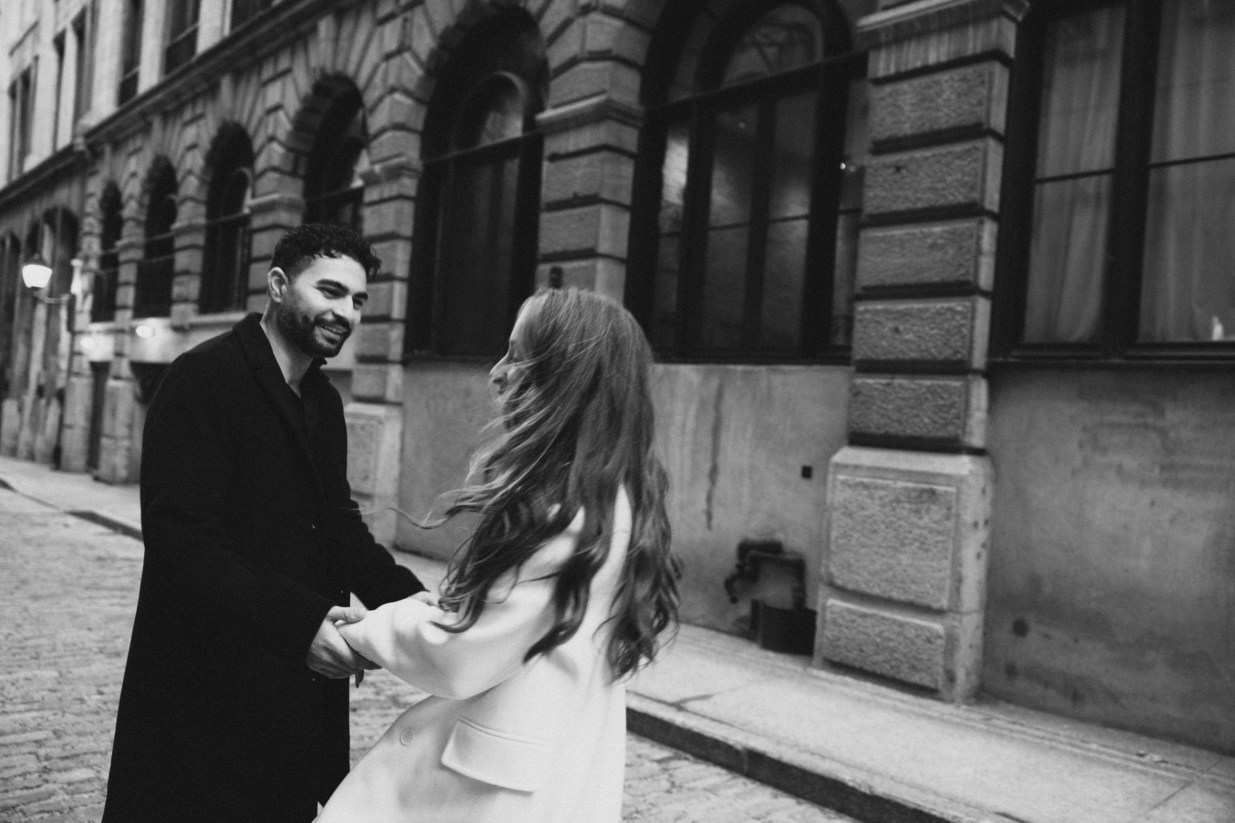 Couple laughing and holding hands on historic Montreal street