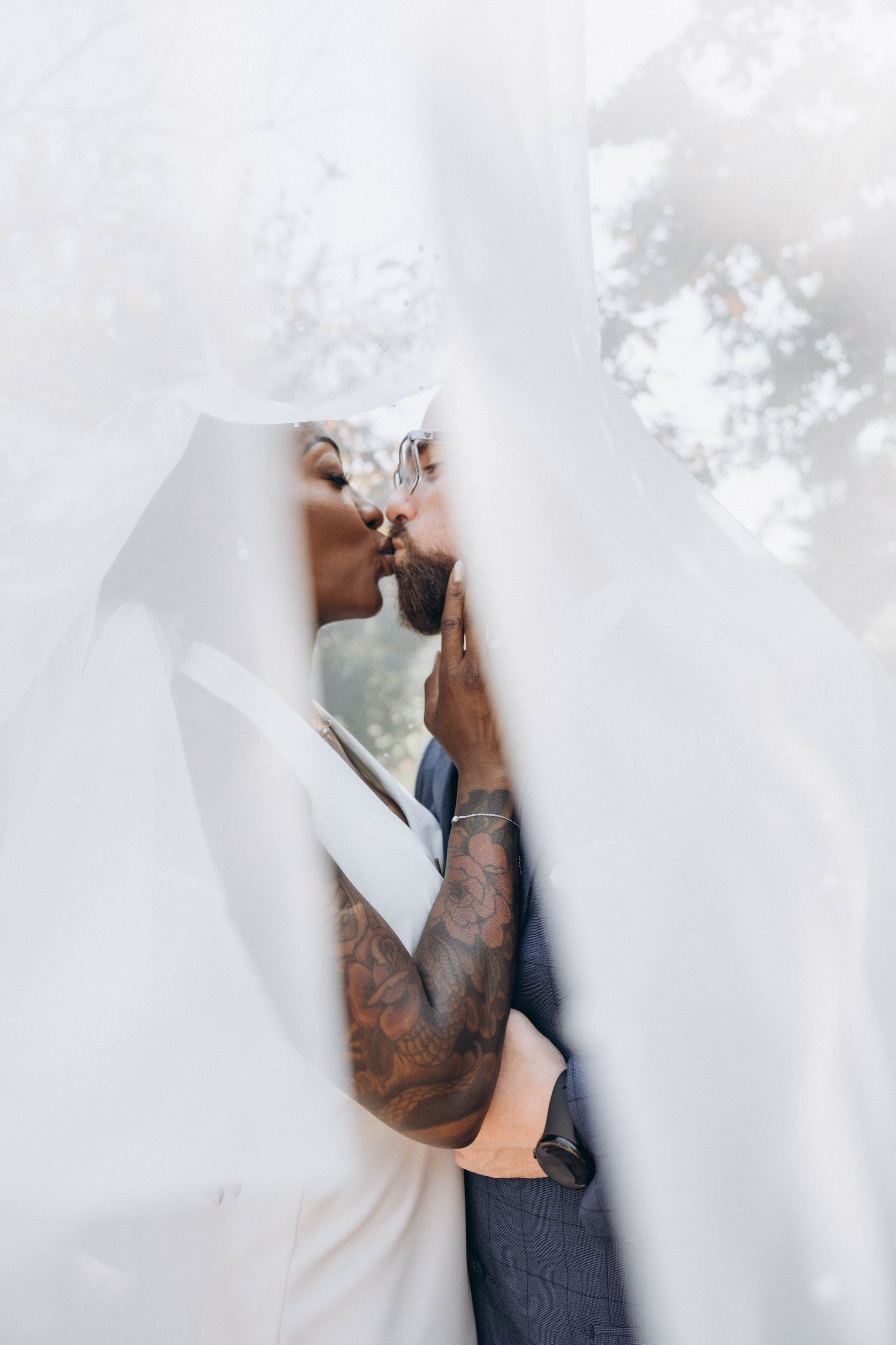 Candid bridal photography with veil flowing in golden hour sunlight