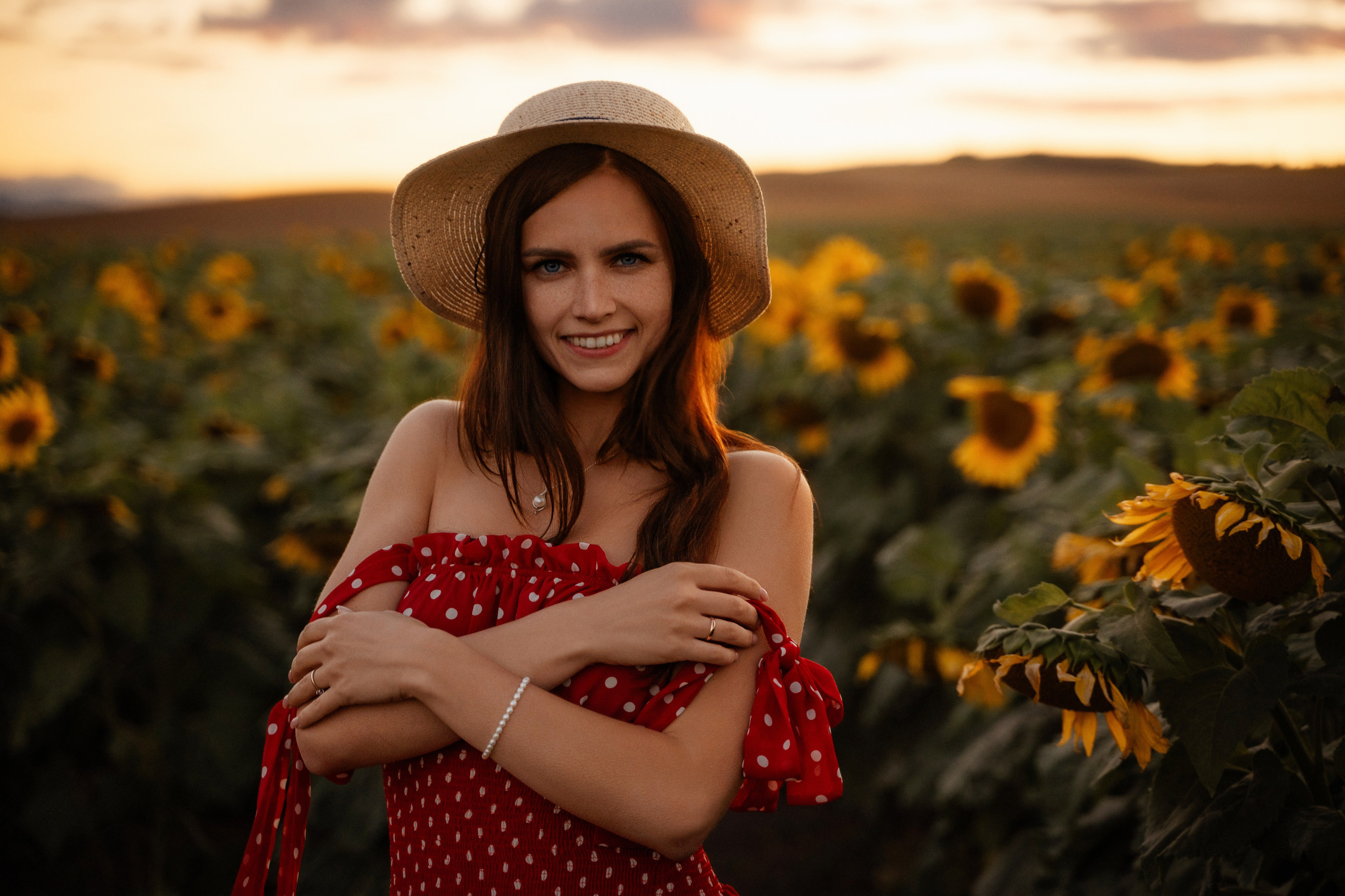 Portrait of female model at sunset in sunflower field, captured by Marbella photographer
