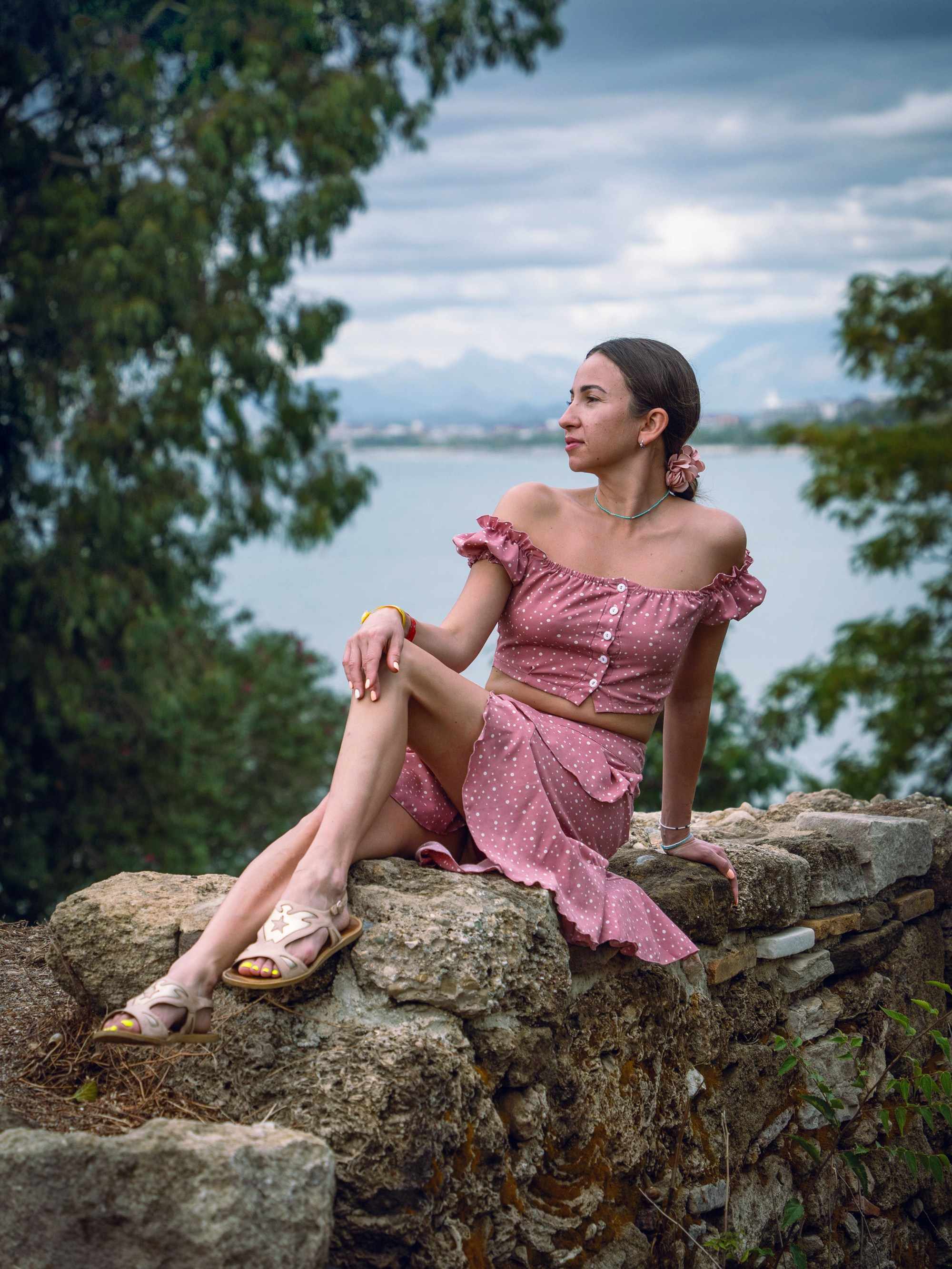 Female portrait sitting on rocks outdoors, lifestyle portrait photography