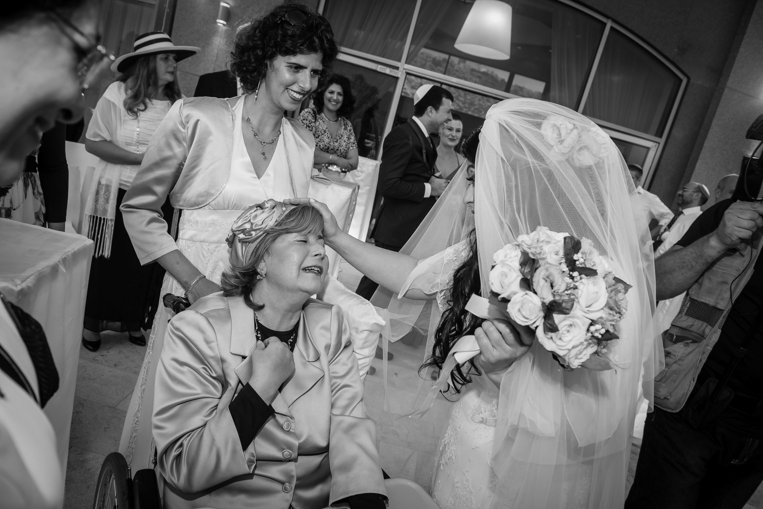 Bride Simone sharing an emotional and tearful moment with her family after the ceremony at the Leonardo Hotel in Haifa, Israel