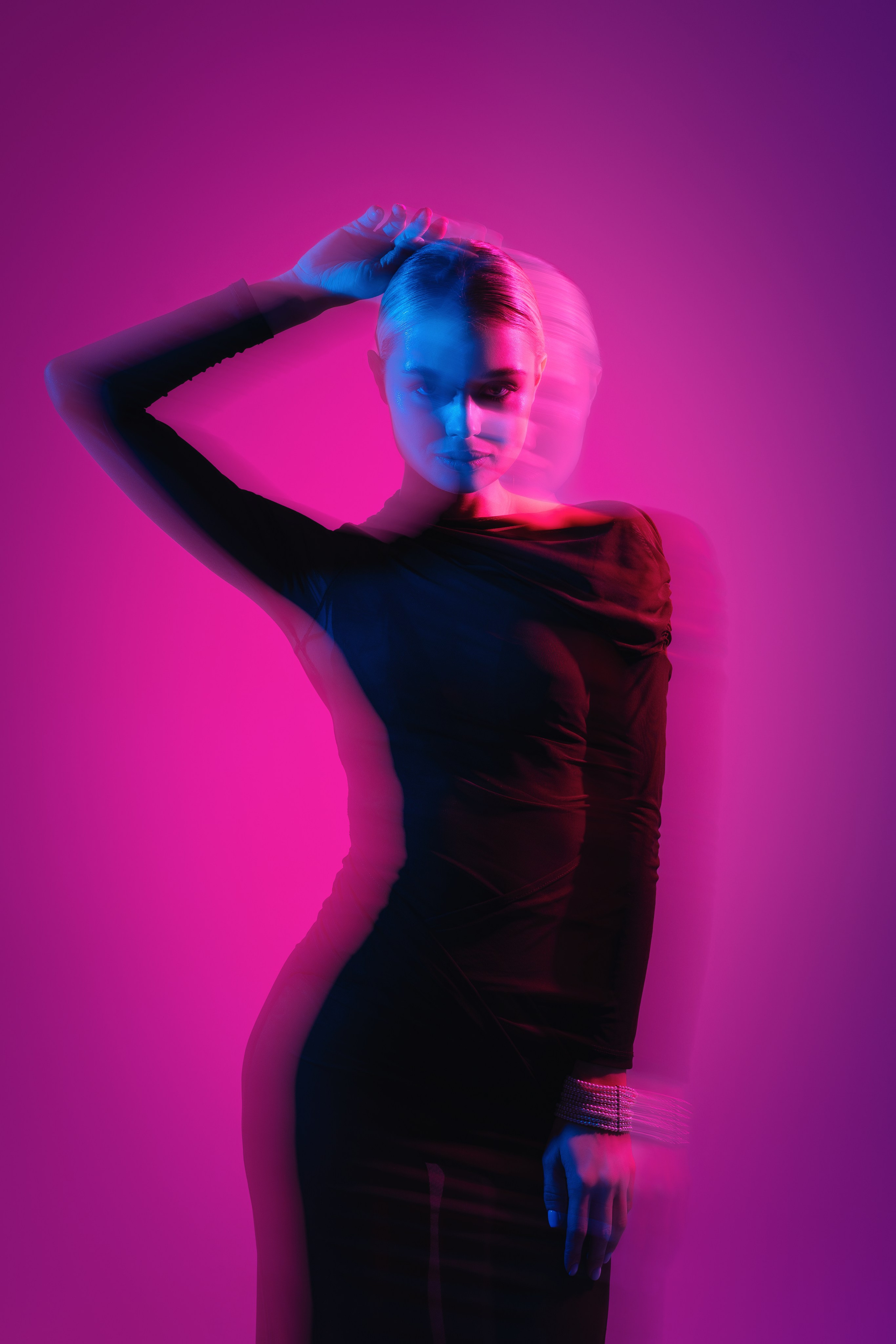 Dynamic Fashion Pose with Dramatic Lighting – A model posing in an avant-garde outfit, shot with bold lighting and high contrast to create a striking visual effect that highlights both the fashion and the model’s attitude