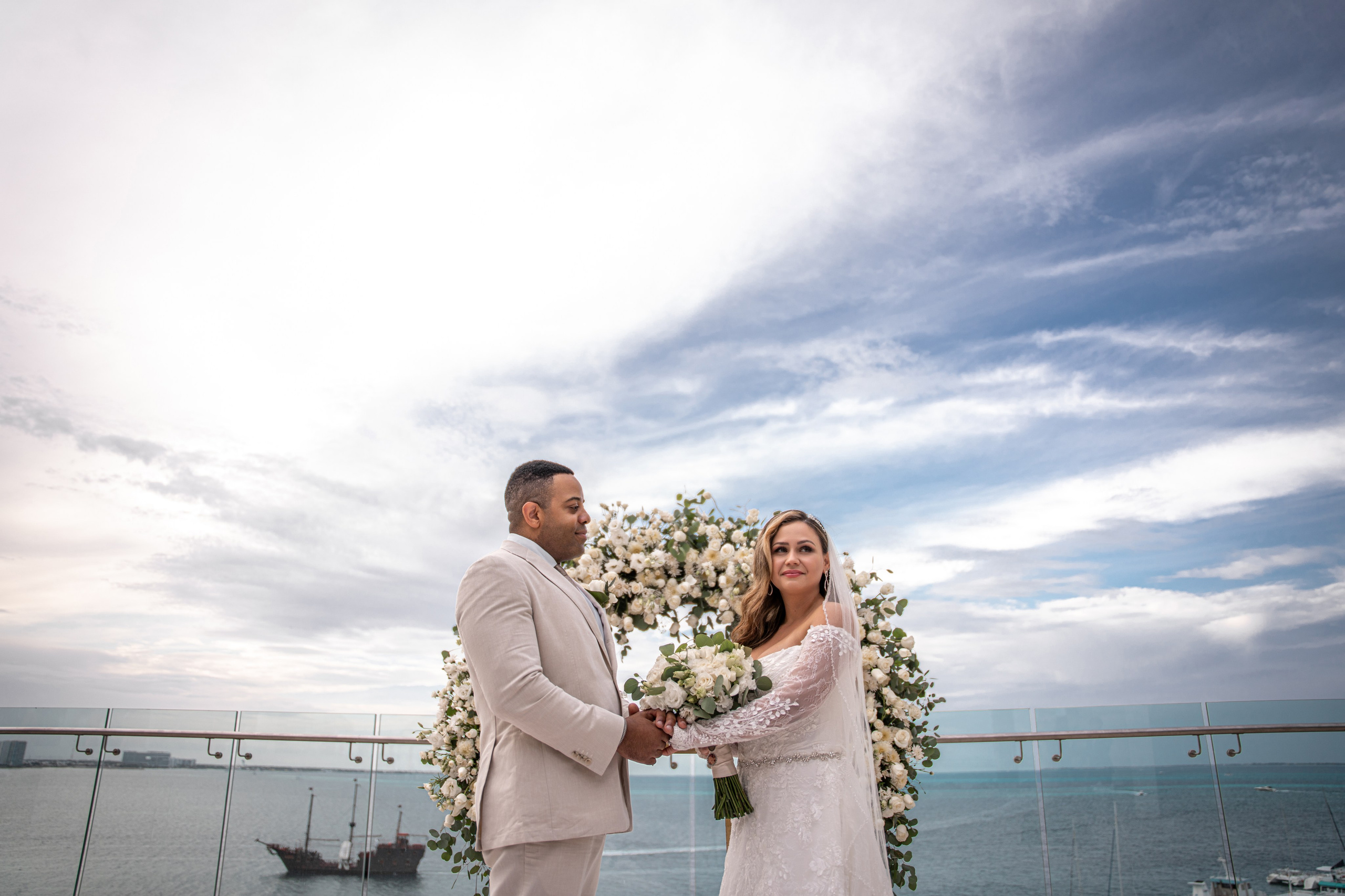 Bride and groom exchanging vows with ocean view in Mexico