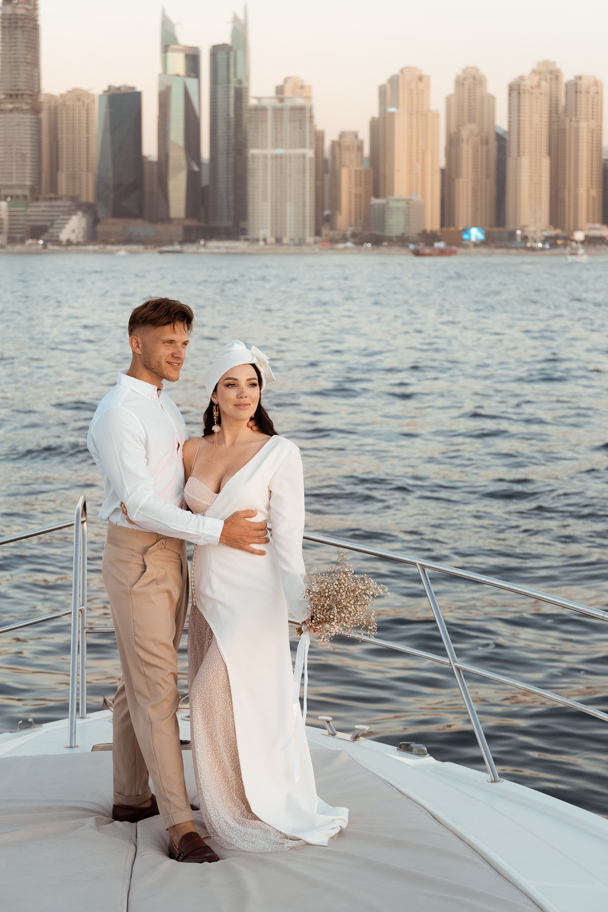 A couple’s love story told through portraits on a yacht: together, they share an embrace. Dubai, United Arab Emirates