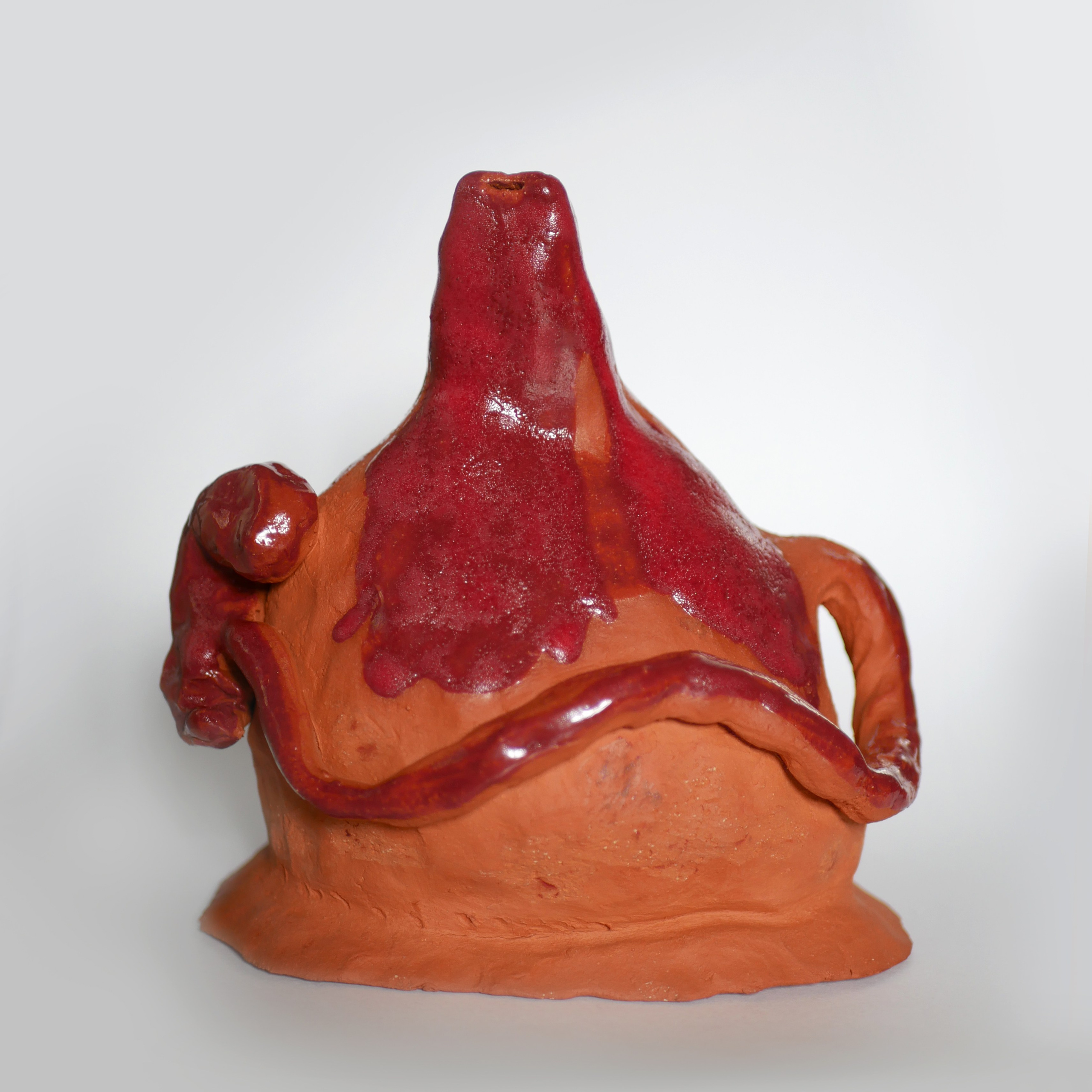 ‘Me and my baby’, red clay sculpture looks like a vessel without a bottom combined with an ocarina on the top. Inside the object, there is a small speaker with a sound of the object itself. The reference is the sounds that a baby hears in the womb.