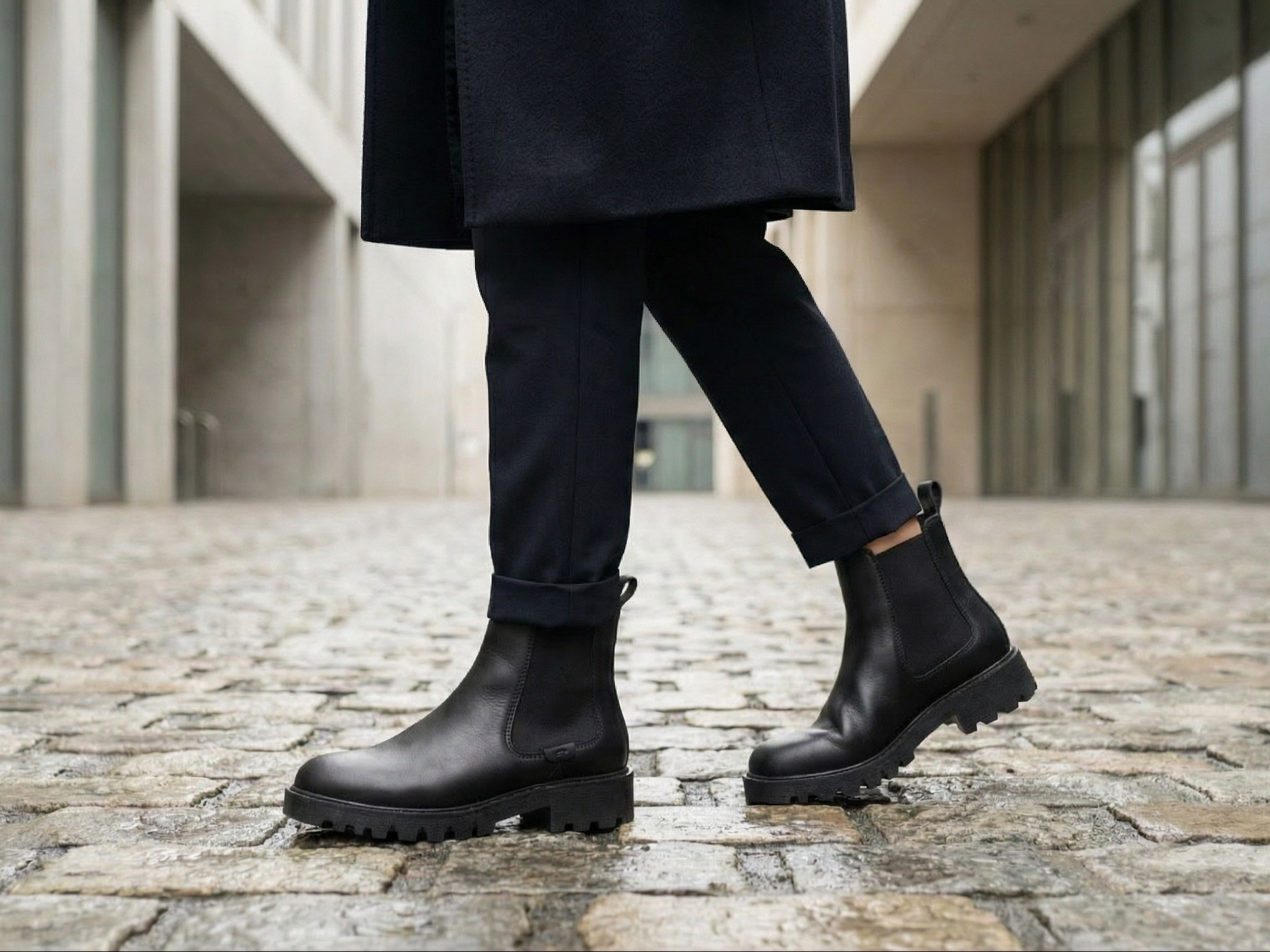 AI lifestyle image black Chelsea boots fashion editorial architectural background