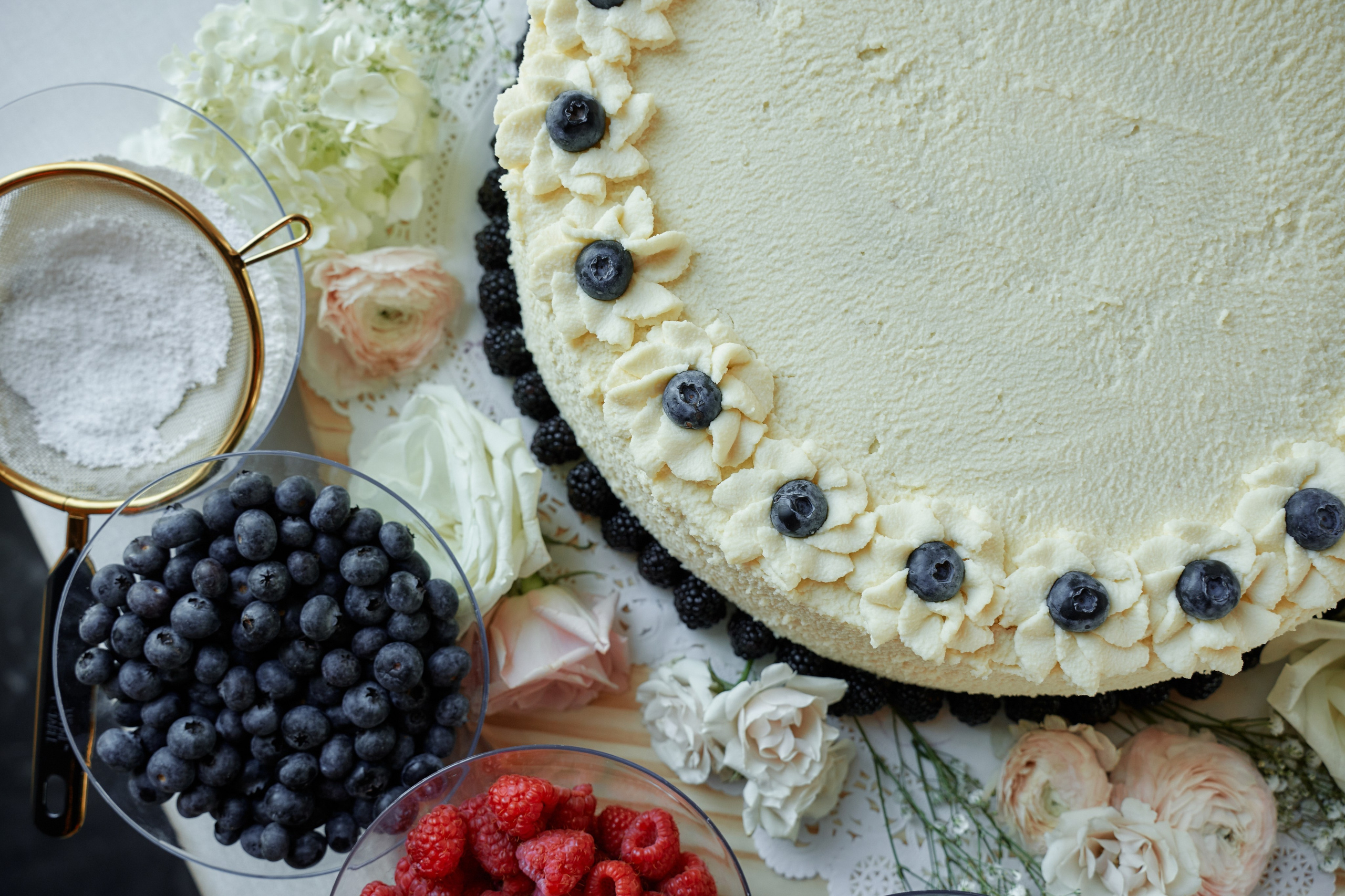 Elegant wedding dessert table with cake and fresh berries at New York wedding reception
