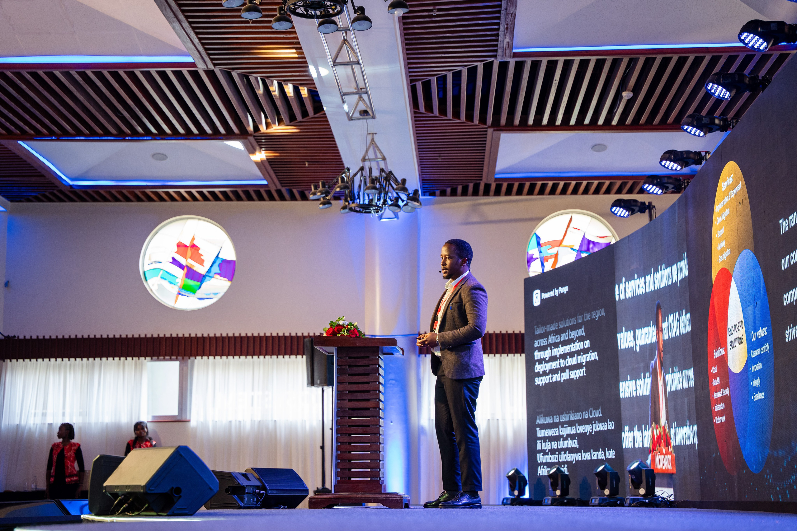 Low-angle speaker shot during corporate leadership event in Nairobi.