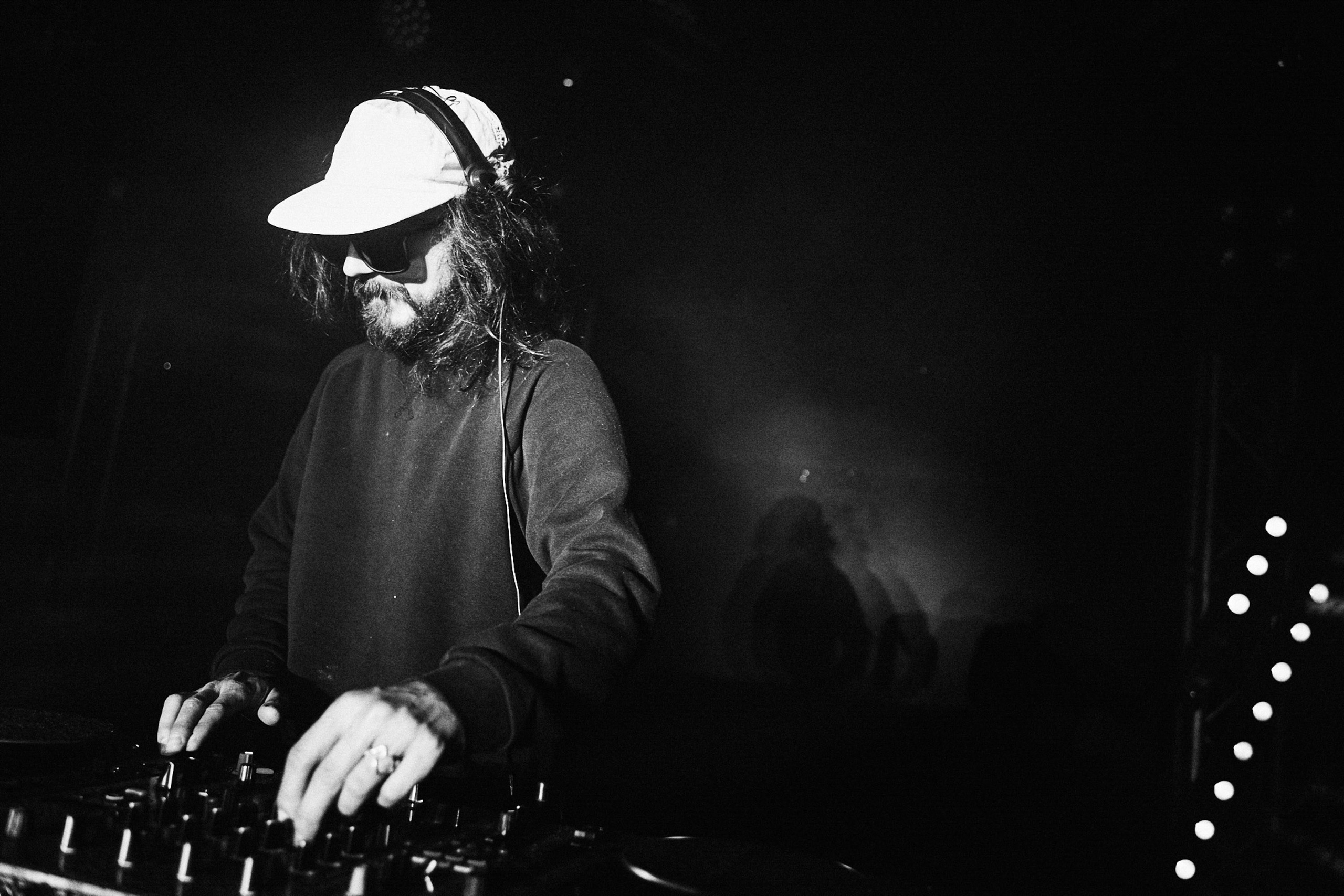 DJ playing music in dark club