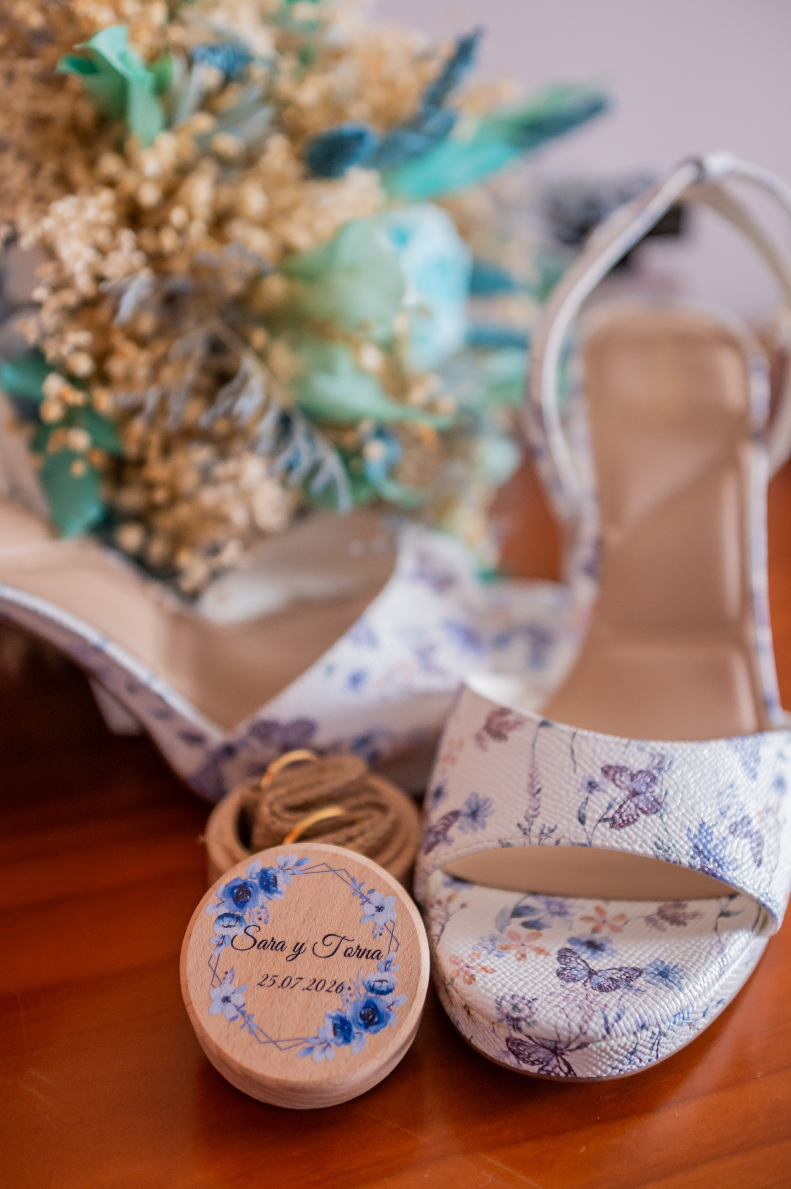 Zapatos de novia junto al ramo y los anillos