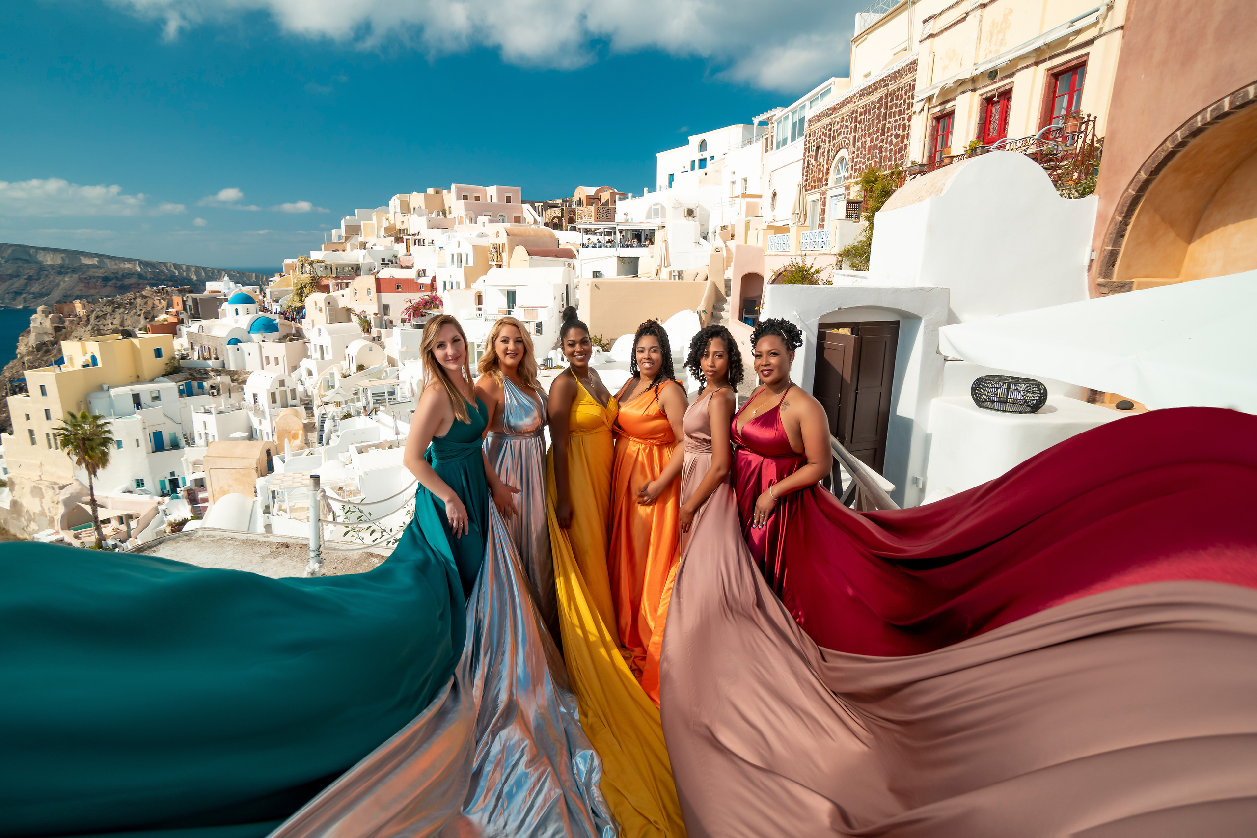 Book a memorable group photoshoot in Santorini with Sokolove. Choose from a variety of flying dresses, including custom color combinations and discounted group prices