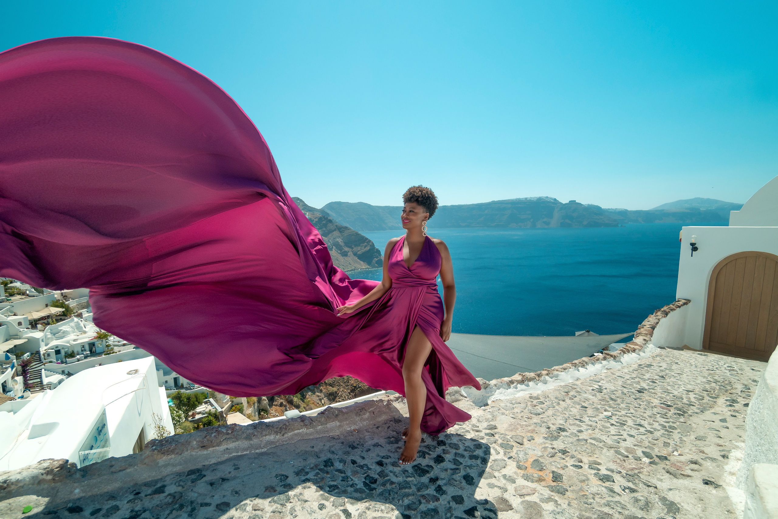 One of the group participants group photoshooting in Santorini. Photographer in Santorini SokoLOVE Alex| Flying Dress Santorini