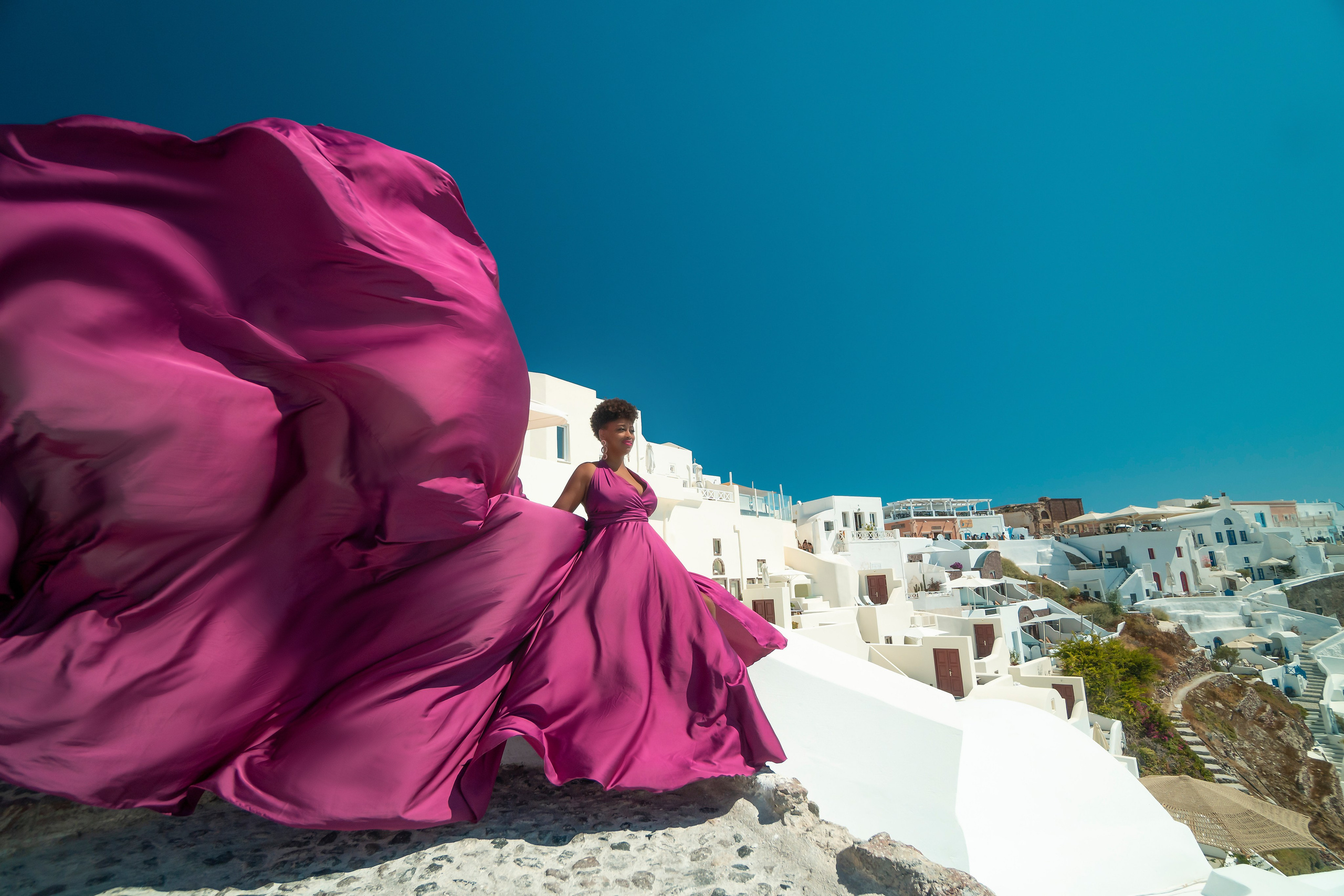 One of the group participants group photoshooting in Santorini. Photographer in Santorini SokoLOVE Alex| Flying Dress Santorini