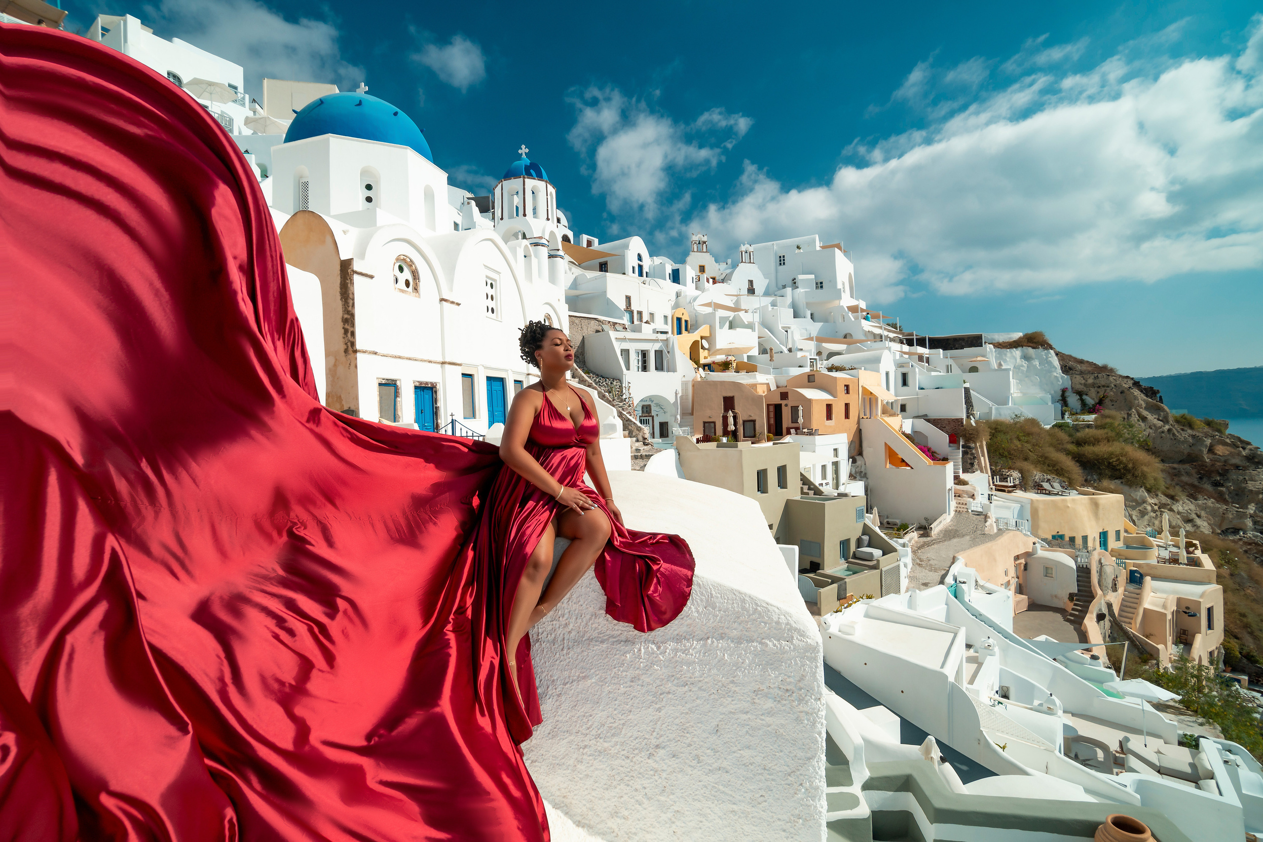 Plus Size Red Wine Satin Flying Dress with V-shaped Back in Santorini (Sizes L-XXXL) for Rent"Book a stunning plus size red wine satin flying dress with a V-shaped back for your photoshoot in Santorini. Available in sizes L-XXXL, this elegant dress is perfect for any destination photoshoot. Rent now and capture breathtaking moments in the most picturesque spots of Santorini!"