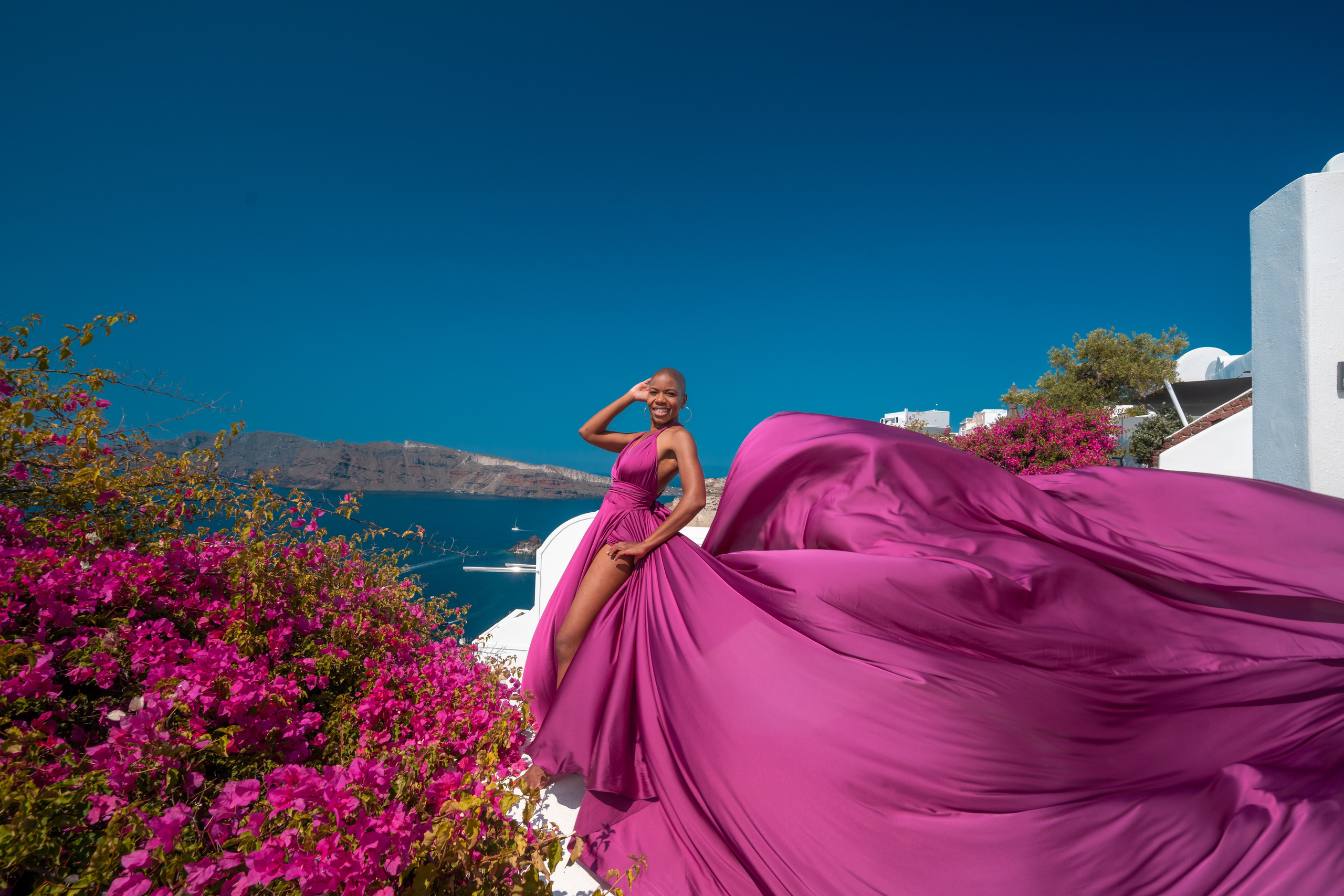 Dark fuchsia flying dress bare back in Santorini. Flying Dress Santorini Photographer | SokoLOVE — Book 2026