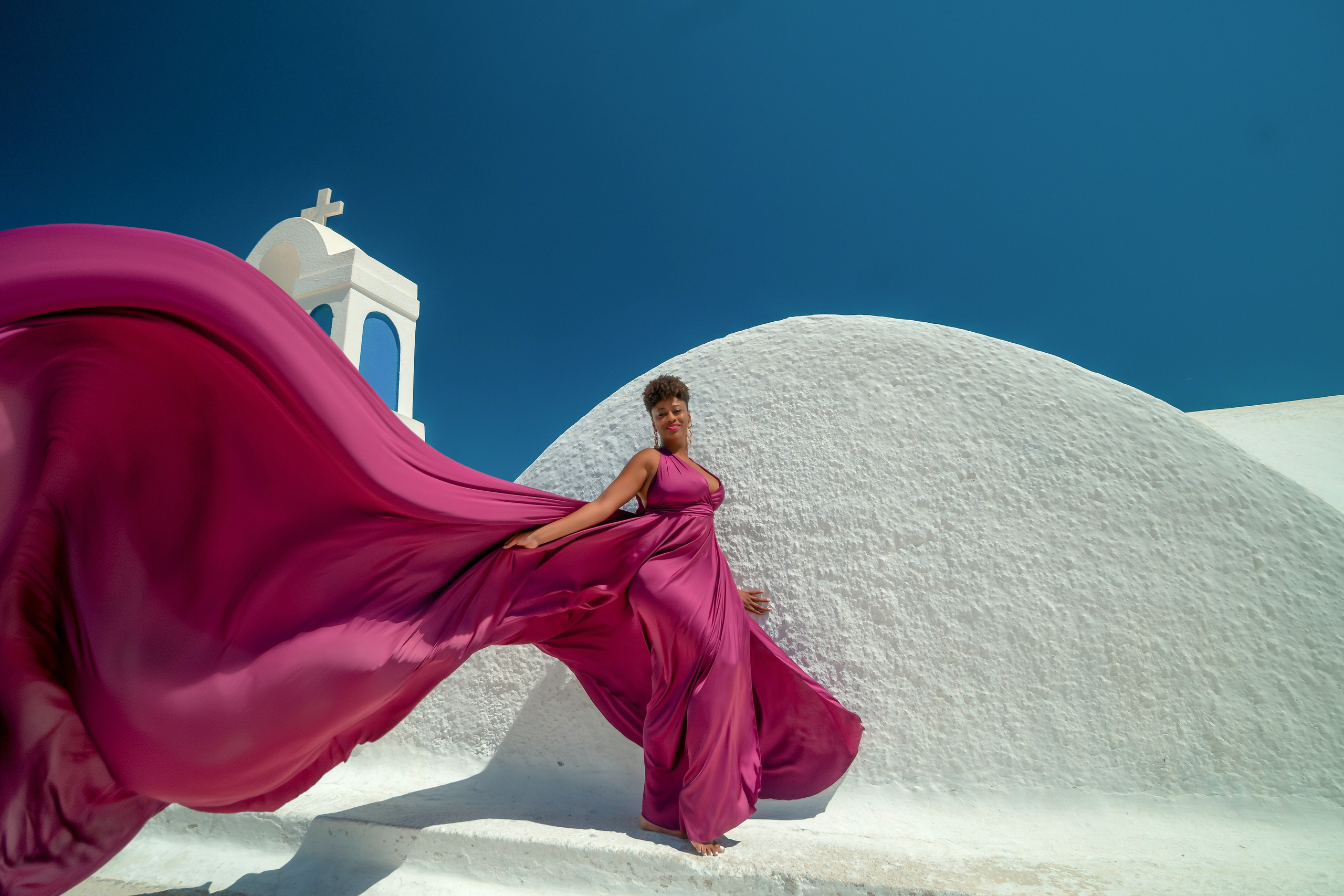 One of the group participants group photoshooting in Santorini. Photographer in Santorini SokoLOVE Alex| Flying Dress Santorini